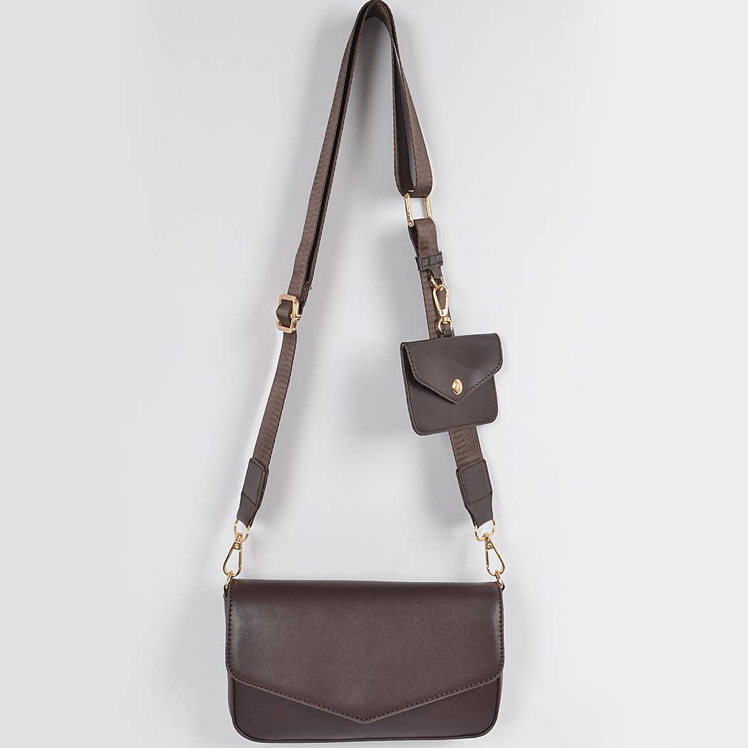 Brown leather crossbody bag with a strap on a light gray background