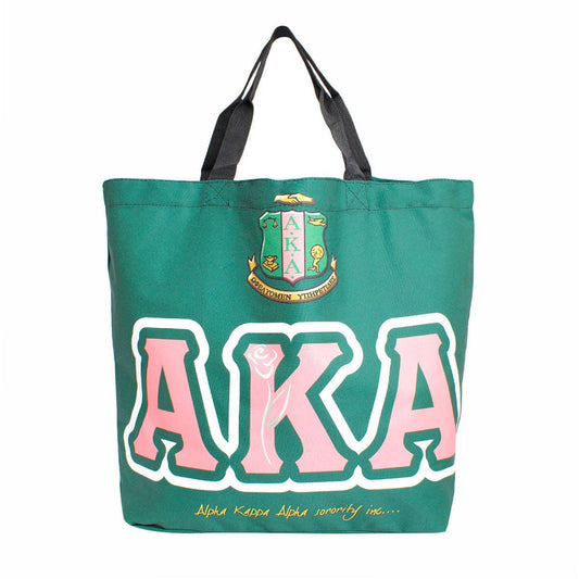 Green tote bag with 'AKA' letters and crest on a white background
