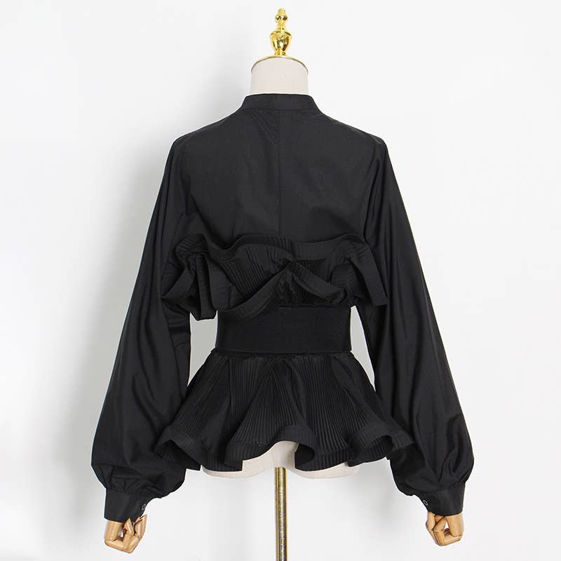 Black blouse with ruffled design on a mannequin against a white background