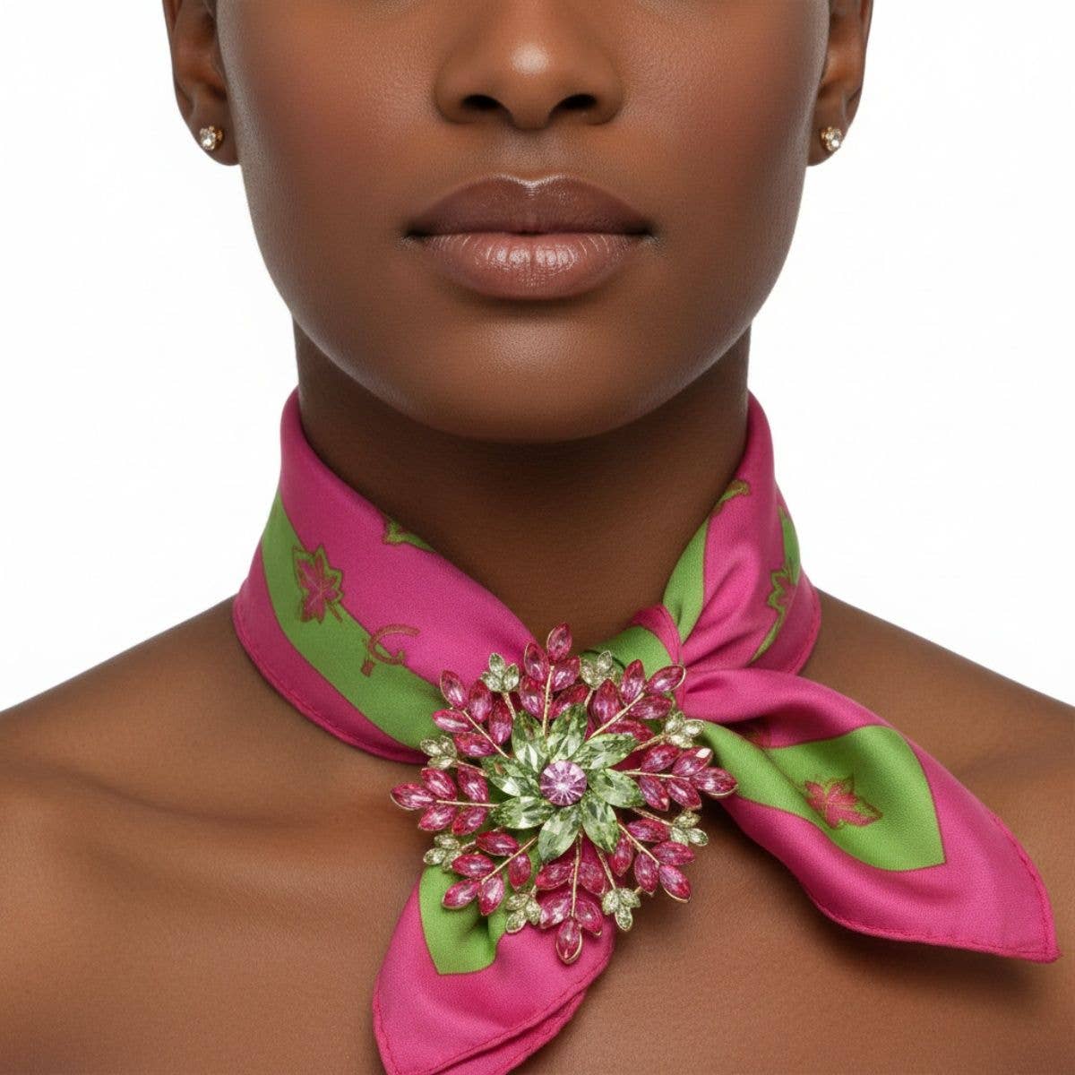 Woman wearing a pink and green embroidered scarf around her neck on a white background