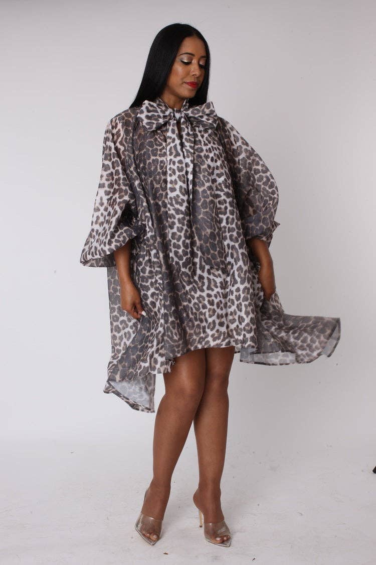 Woman wearing a leopard print dress on a white background