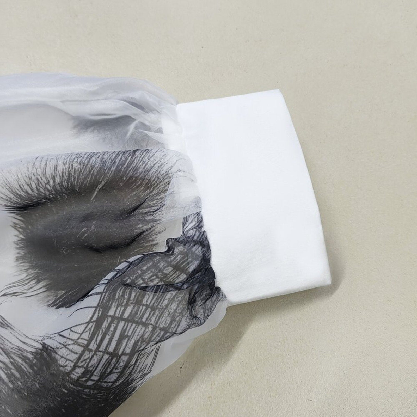 Close-up of a black and white patterned fabric on a beige background