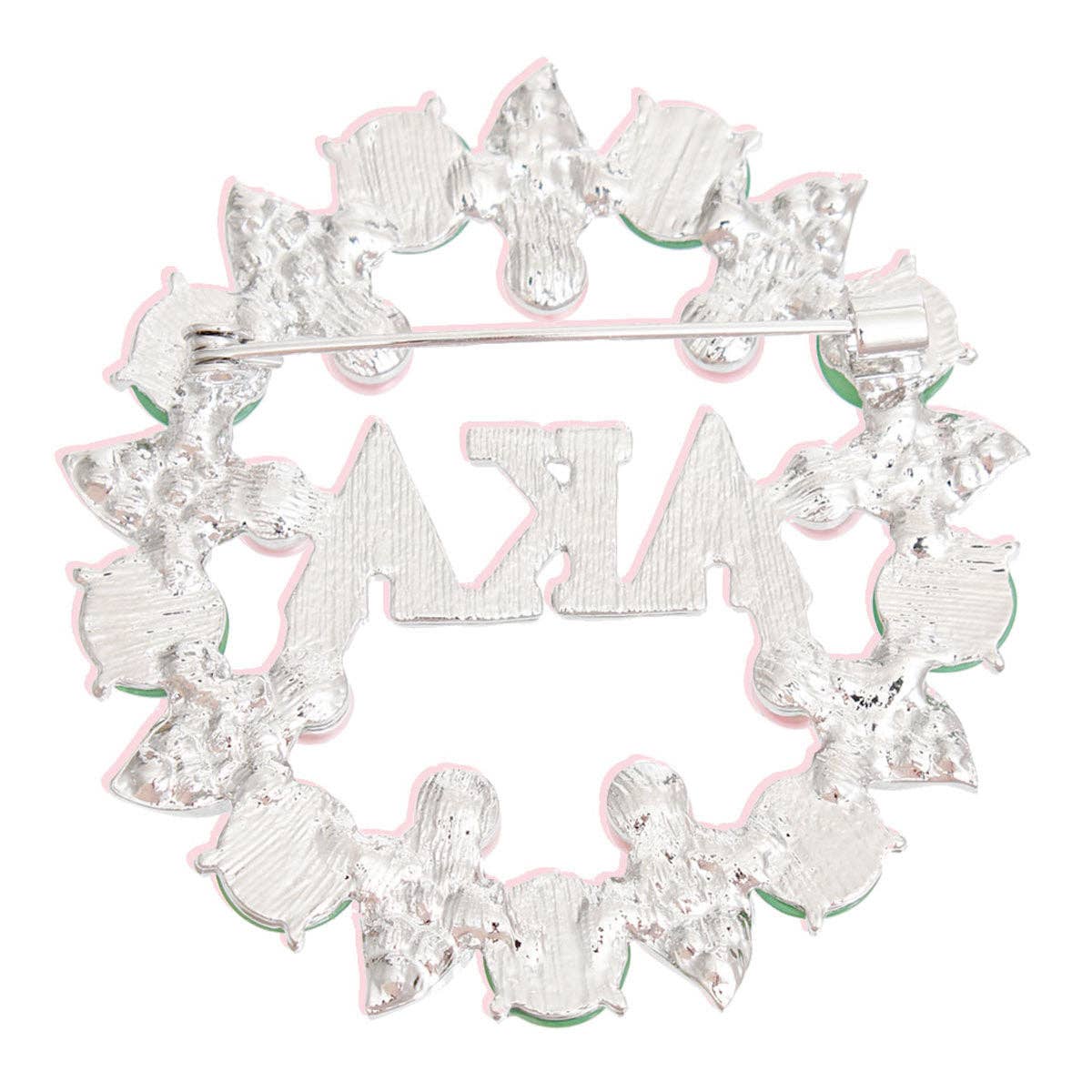 Silver brooch with 'Sigma Xi' letters on a white background