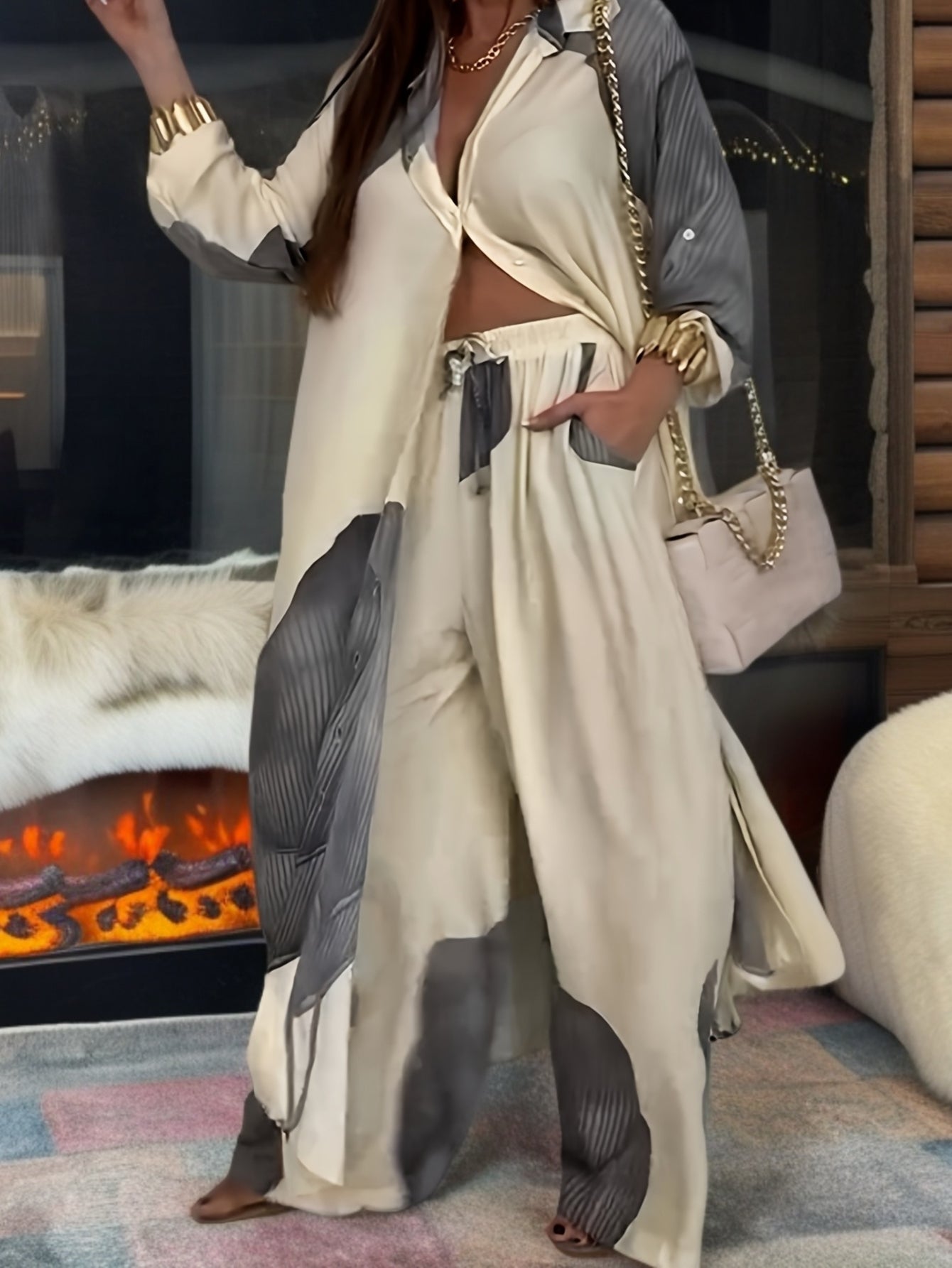 Person wearing a stylish outfit with a fireplace in the background