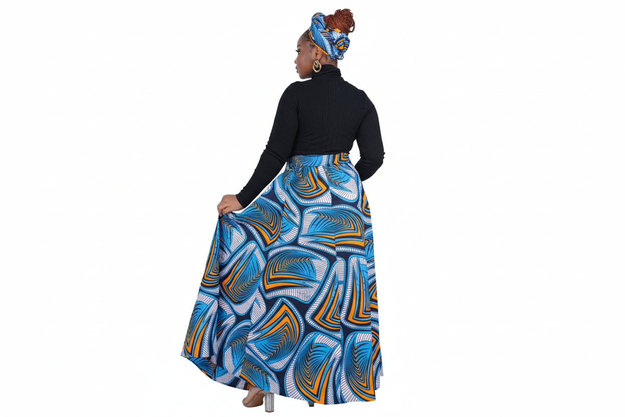 Woman wearing a blue and orange patterned skirt with a black top on a white background