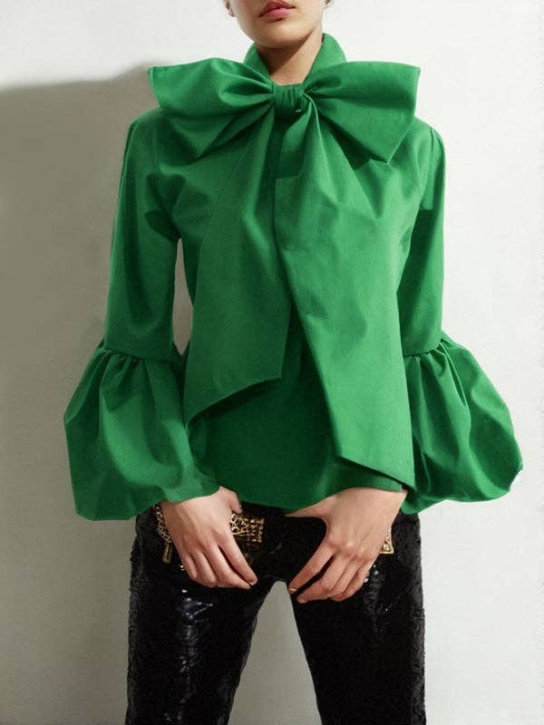Green blouse with a large bow detail on a plain background