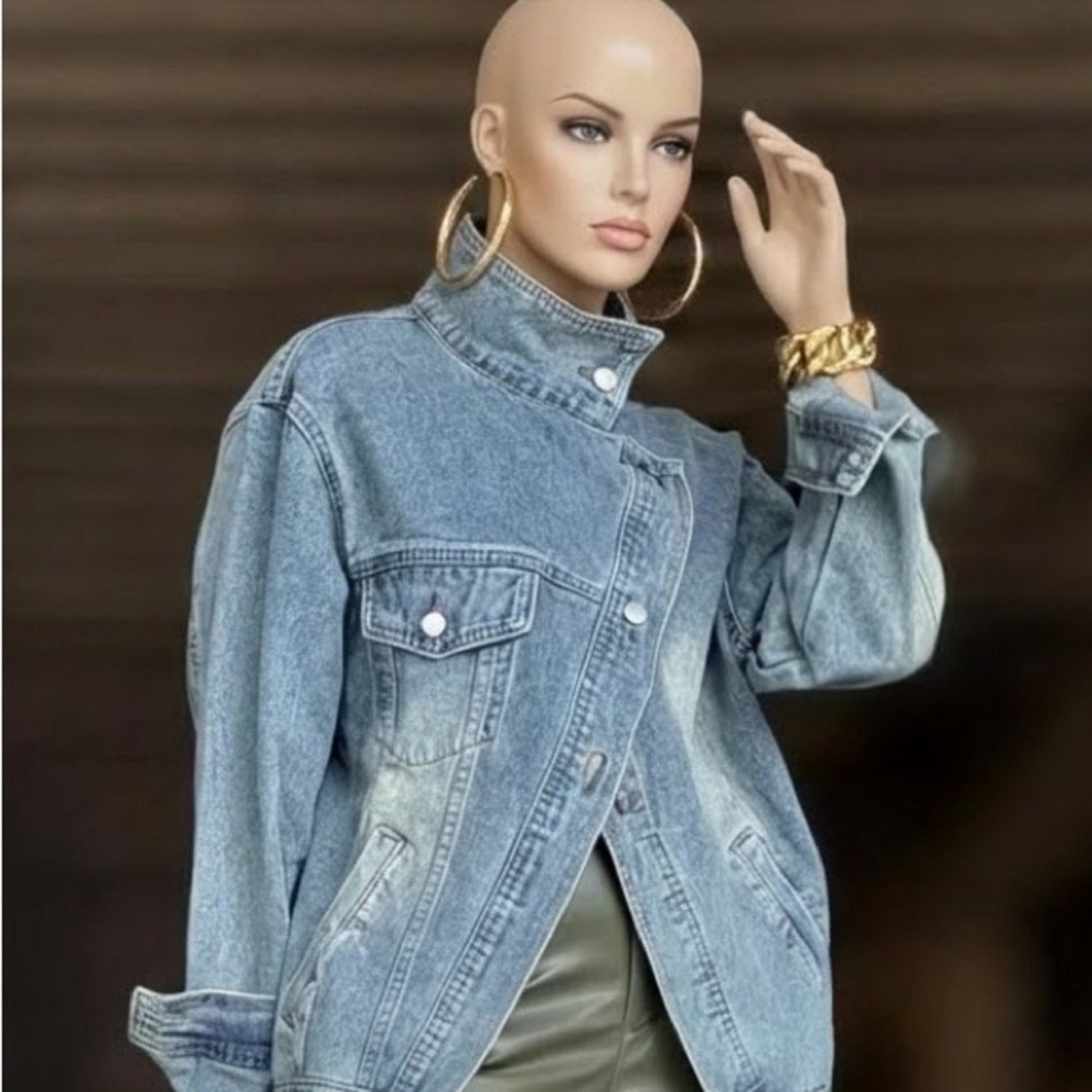 Mannequin wearing a blue denim jacket with a blurred background