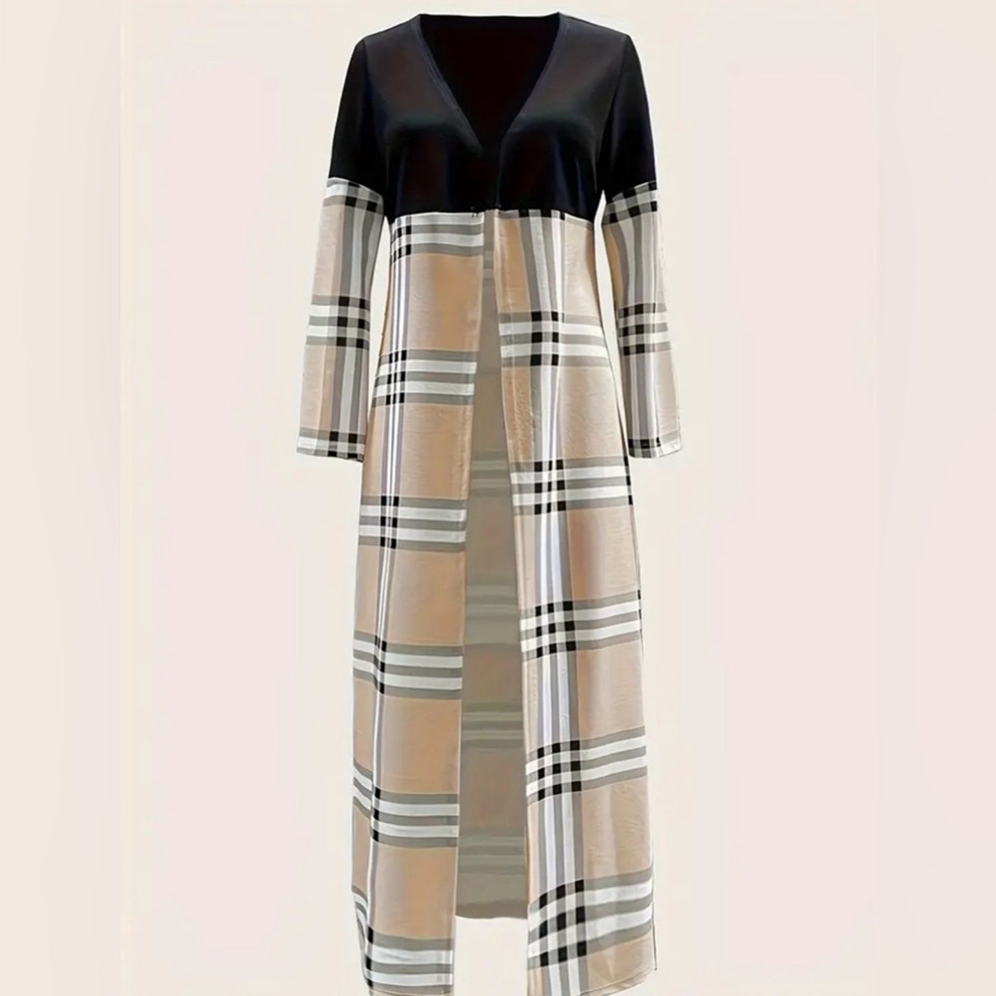 Long dress with black top and plaid pattern on a light pink background