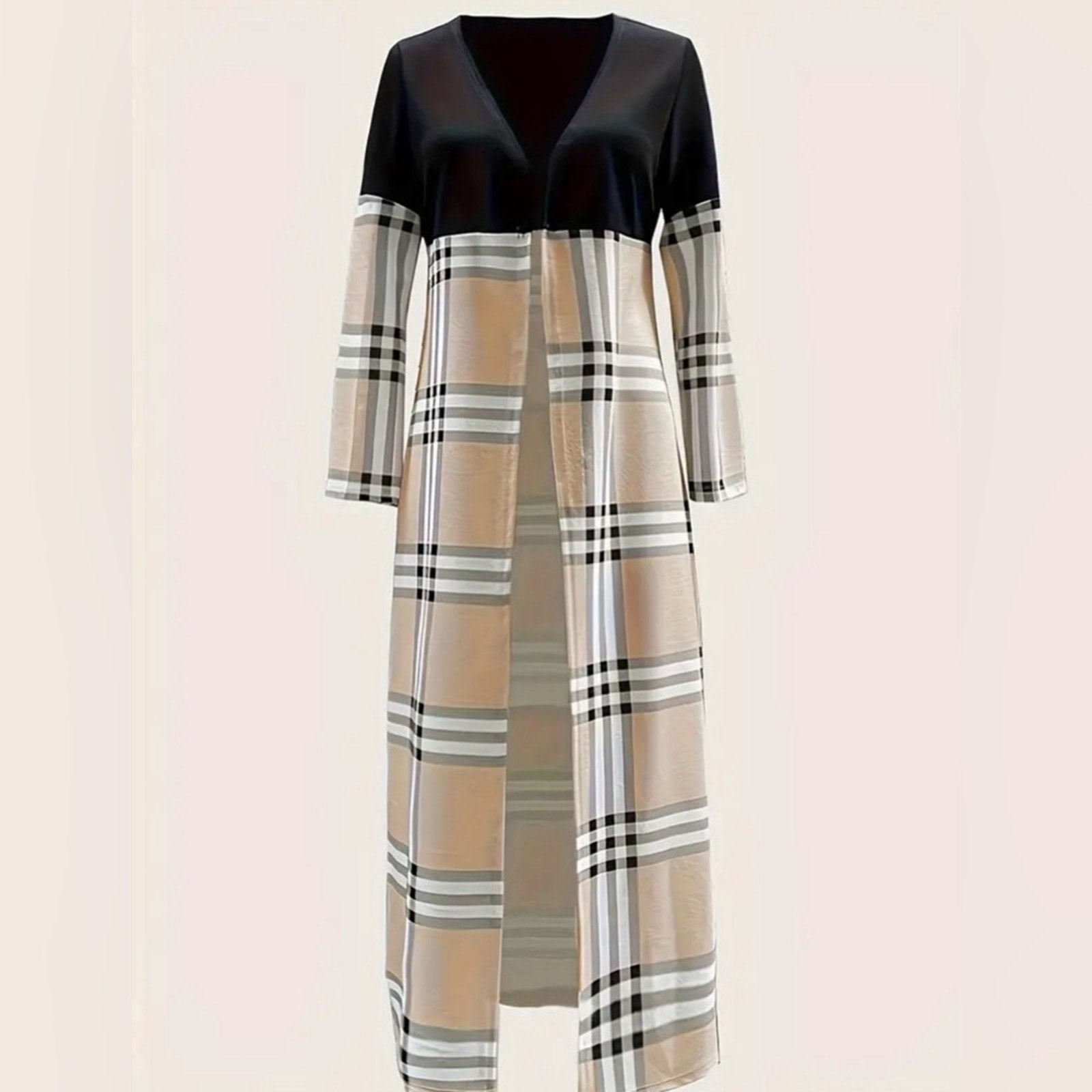 Long dress with black top and plaid pattern on a light pink background