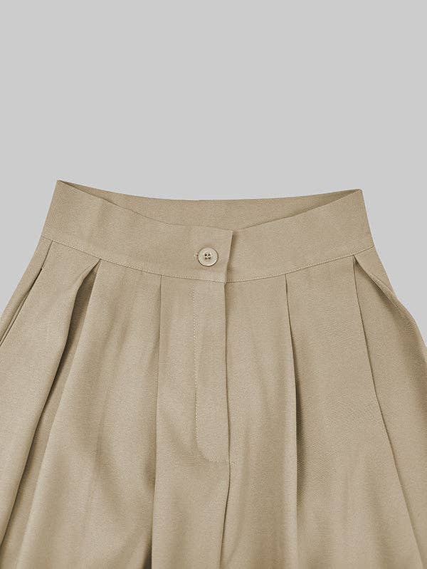 Beige pleated skirt with a button on a light gray background