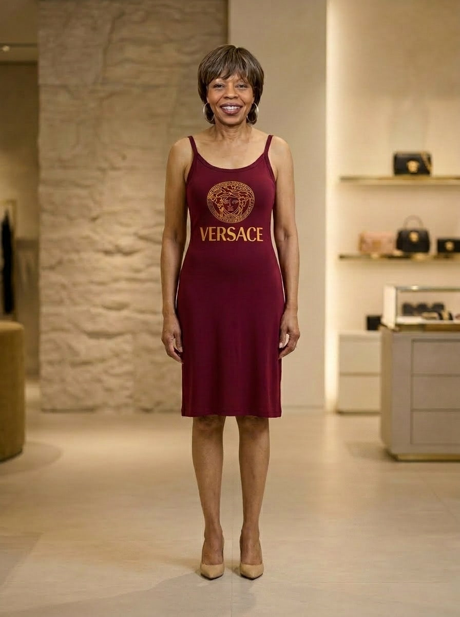 Woman wearing a red Versace dress in an indoor setting