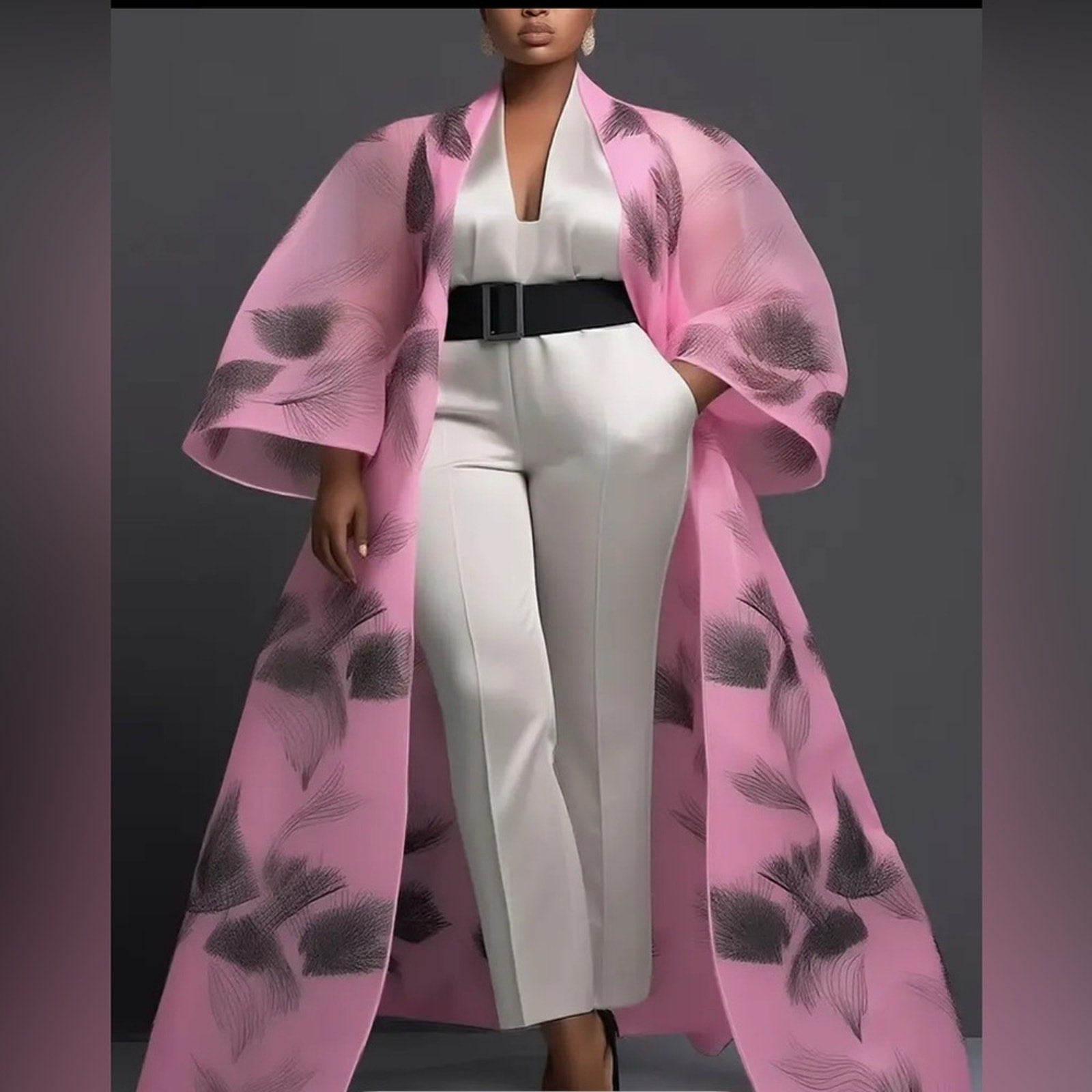 Person wearing a white outfit with a pink floral coat against a gray background