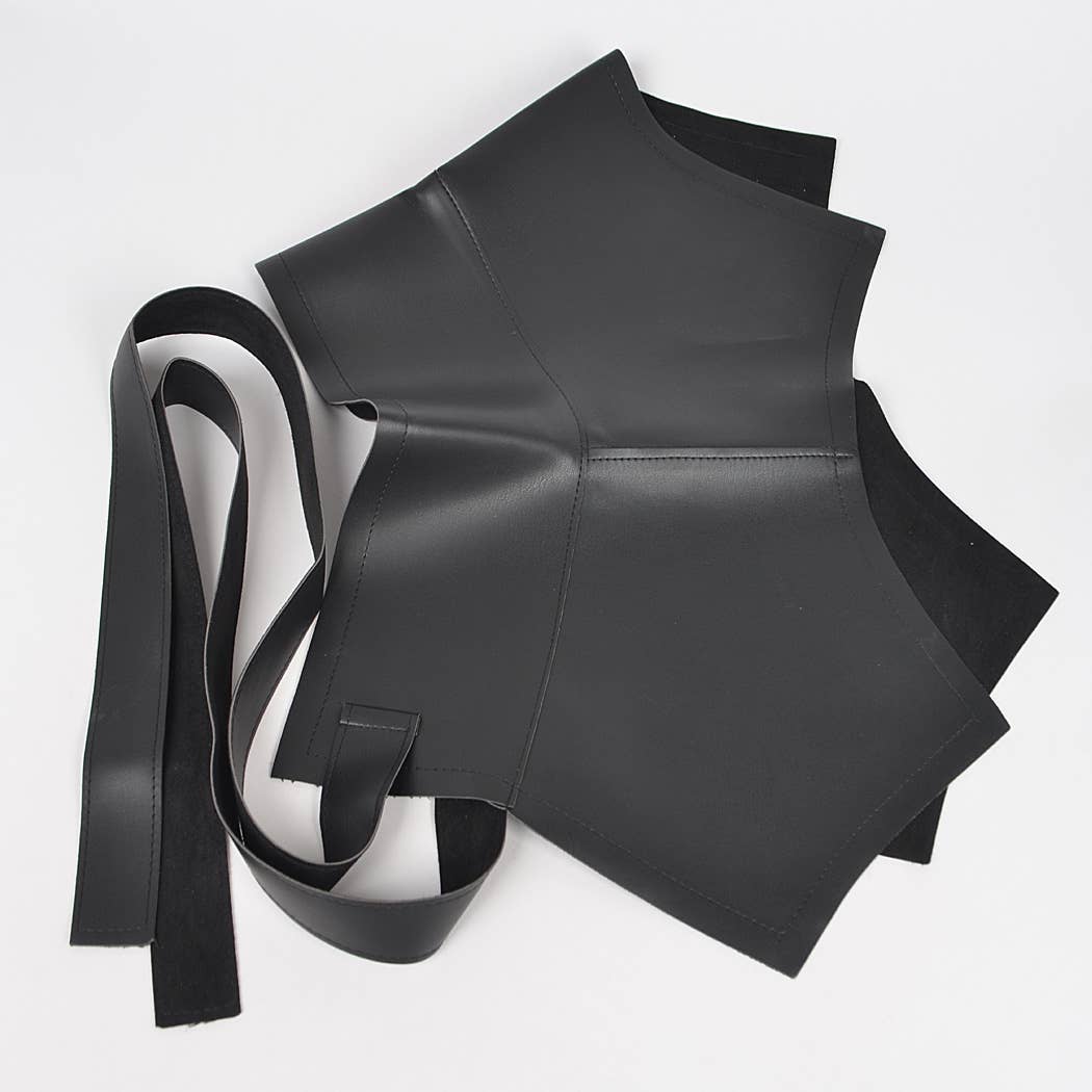 Black leather garment with a strap on a white background