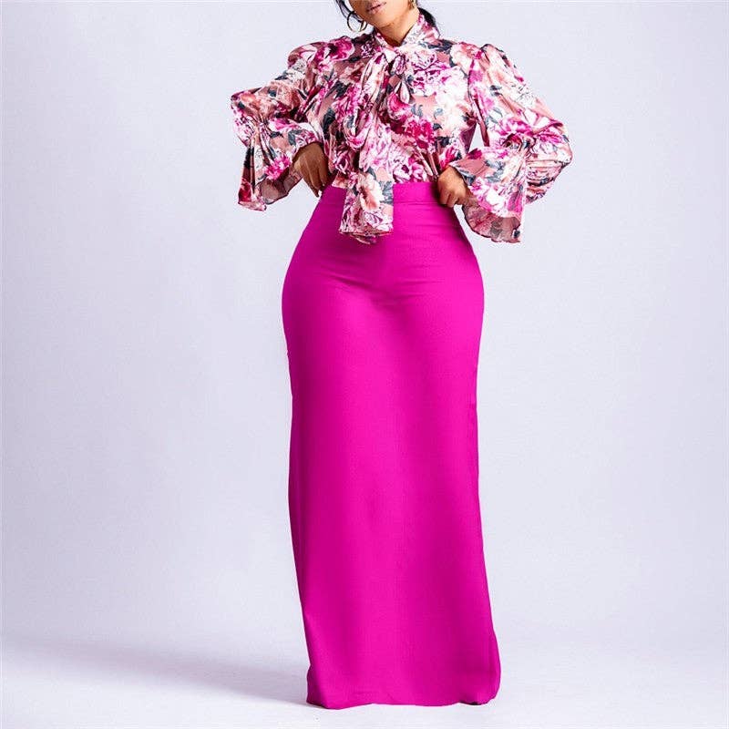 Woman wearing a pink floral top and pink skirt on a white background