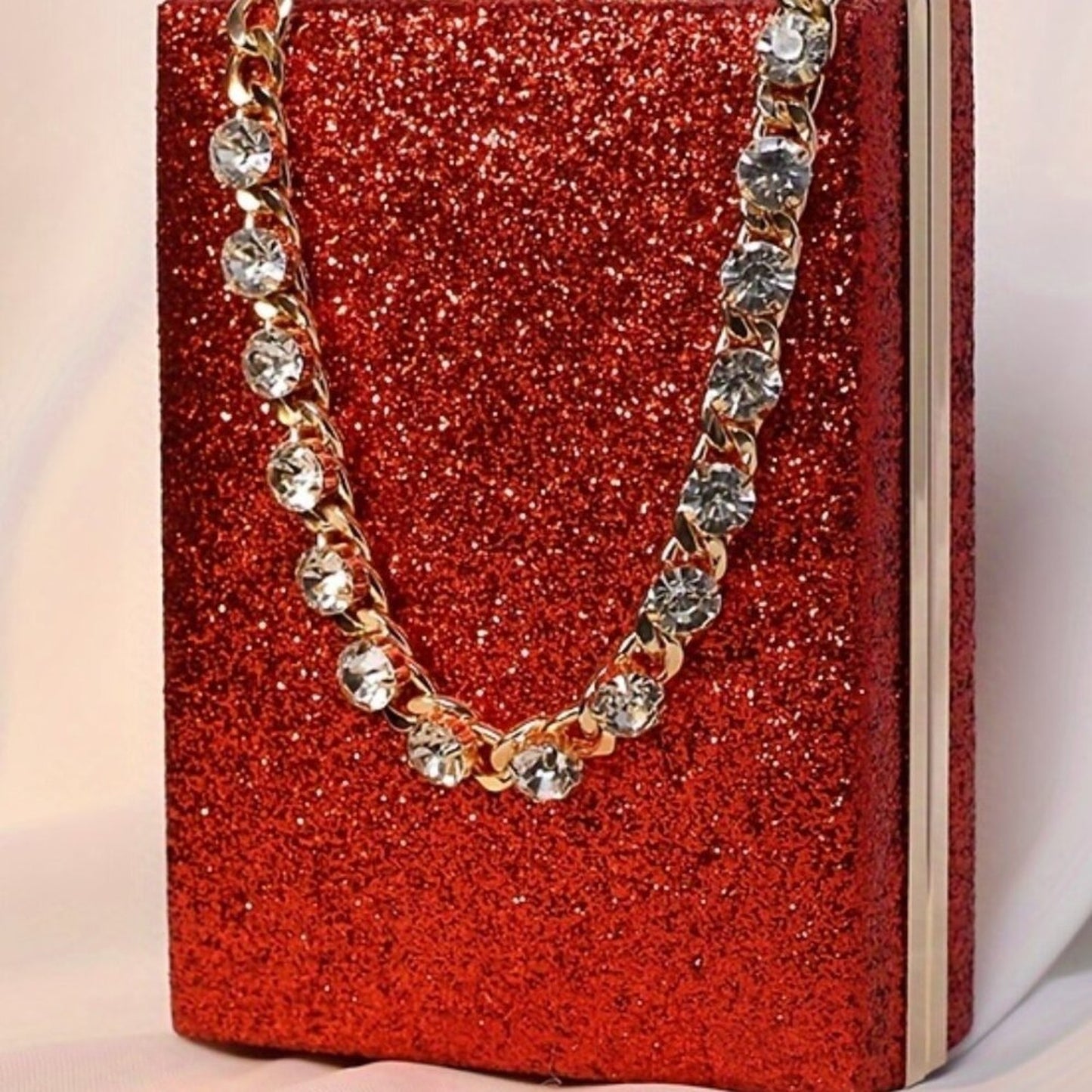 Gold chain necklace with crystals on a red glittery box