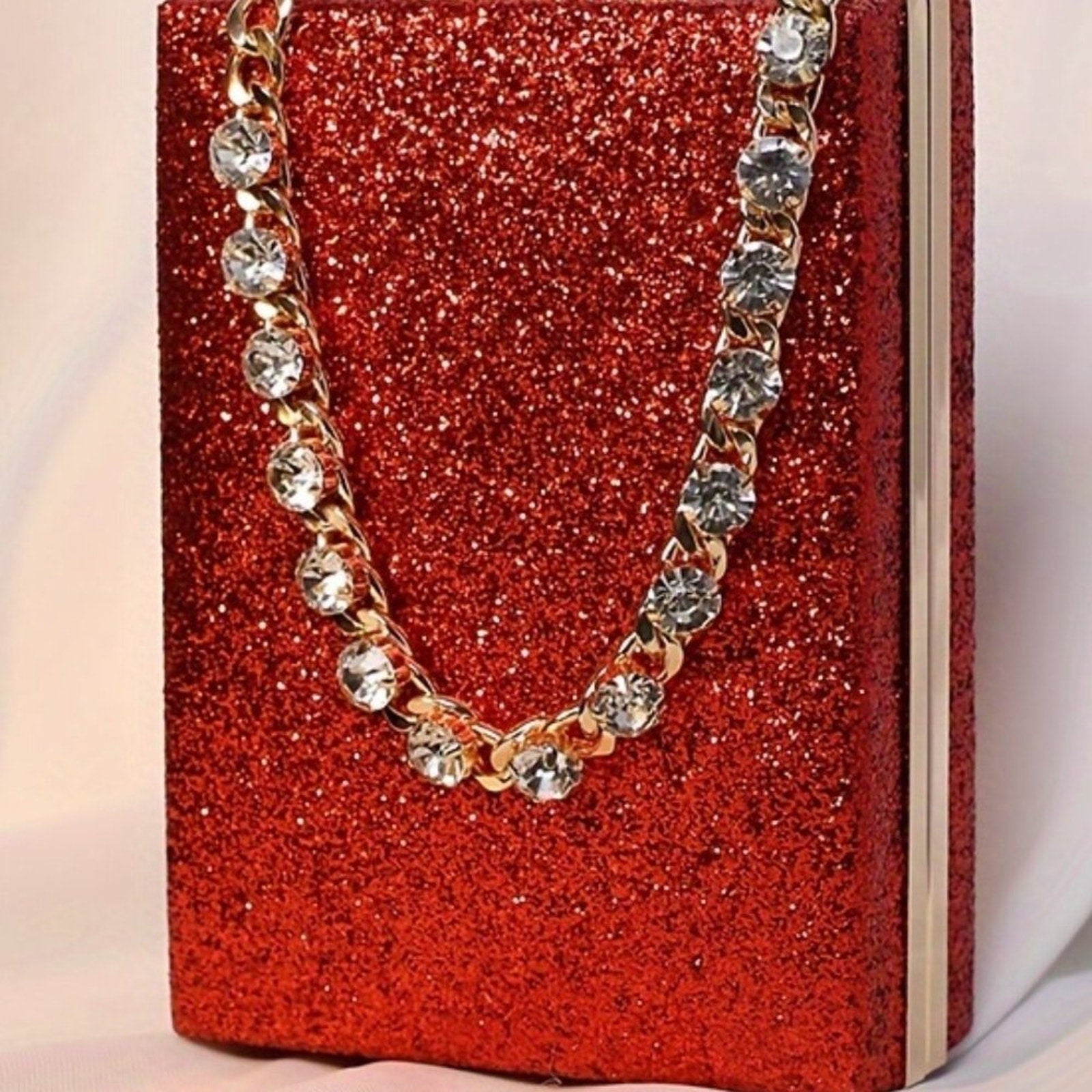 Gold chain necklace with crystals on a red glittery box