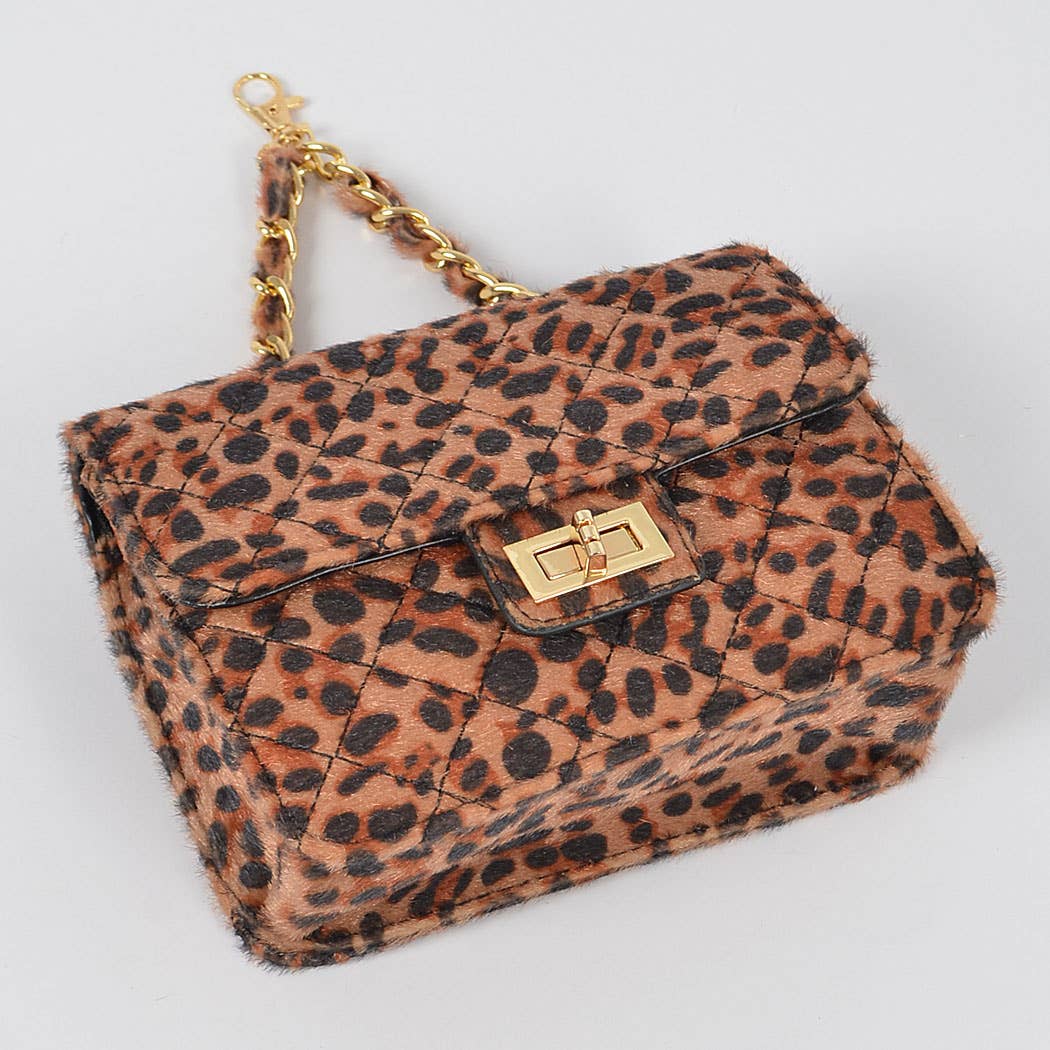 Leopard print handbag with gold chain strap on a light gray background