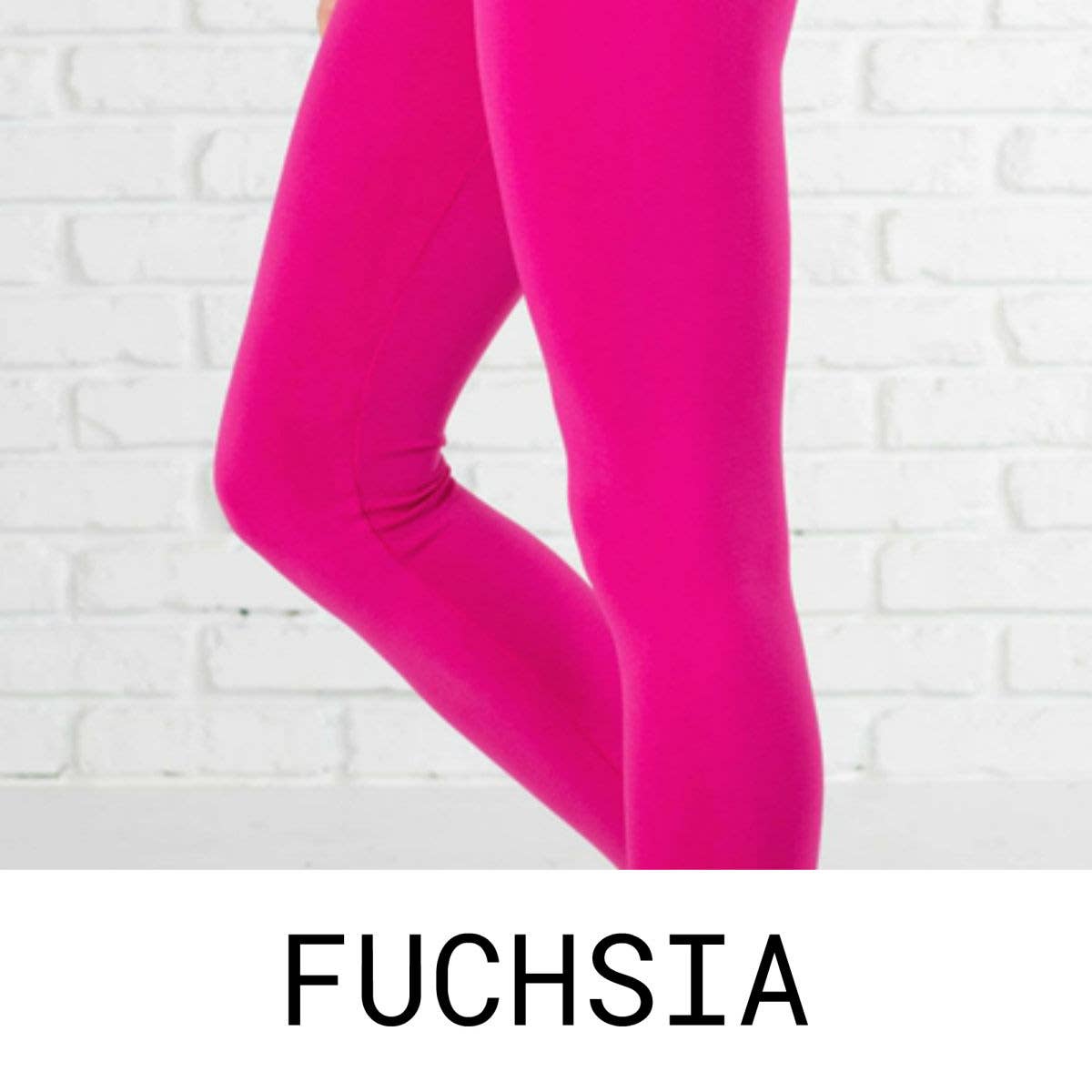 Fuchsia leggings against a white brick wall