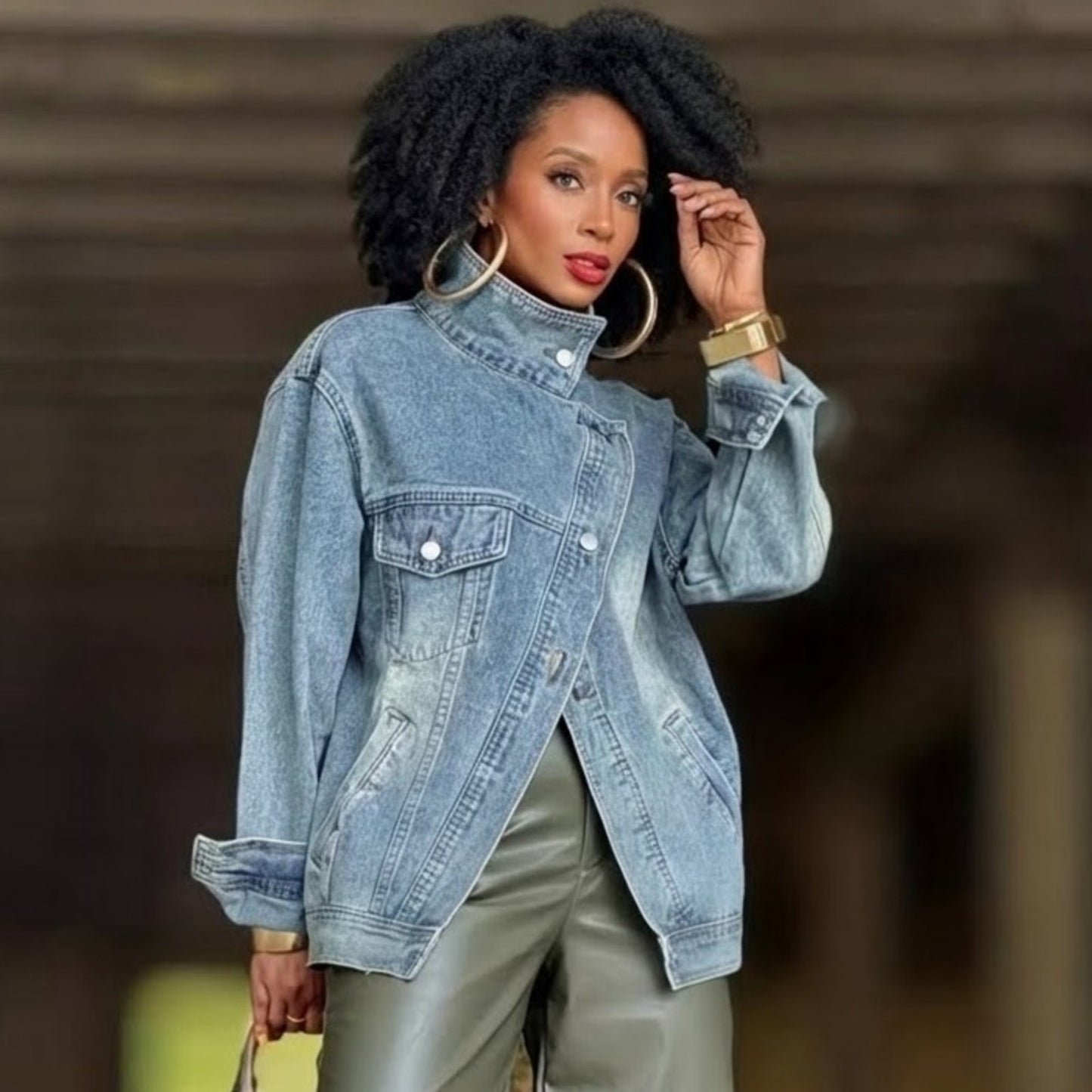 Woman wearing a denim jacket with a blurred background