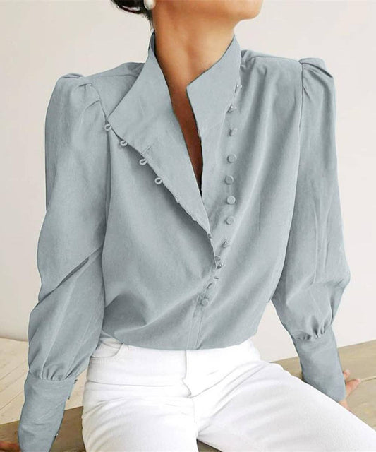 Light blue blouse with long sleeves and a V-neckline worn by a person.
