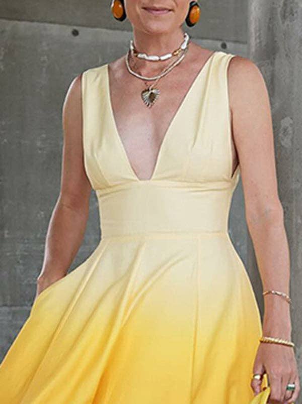 Woman wearing a yellow dress with a gray background