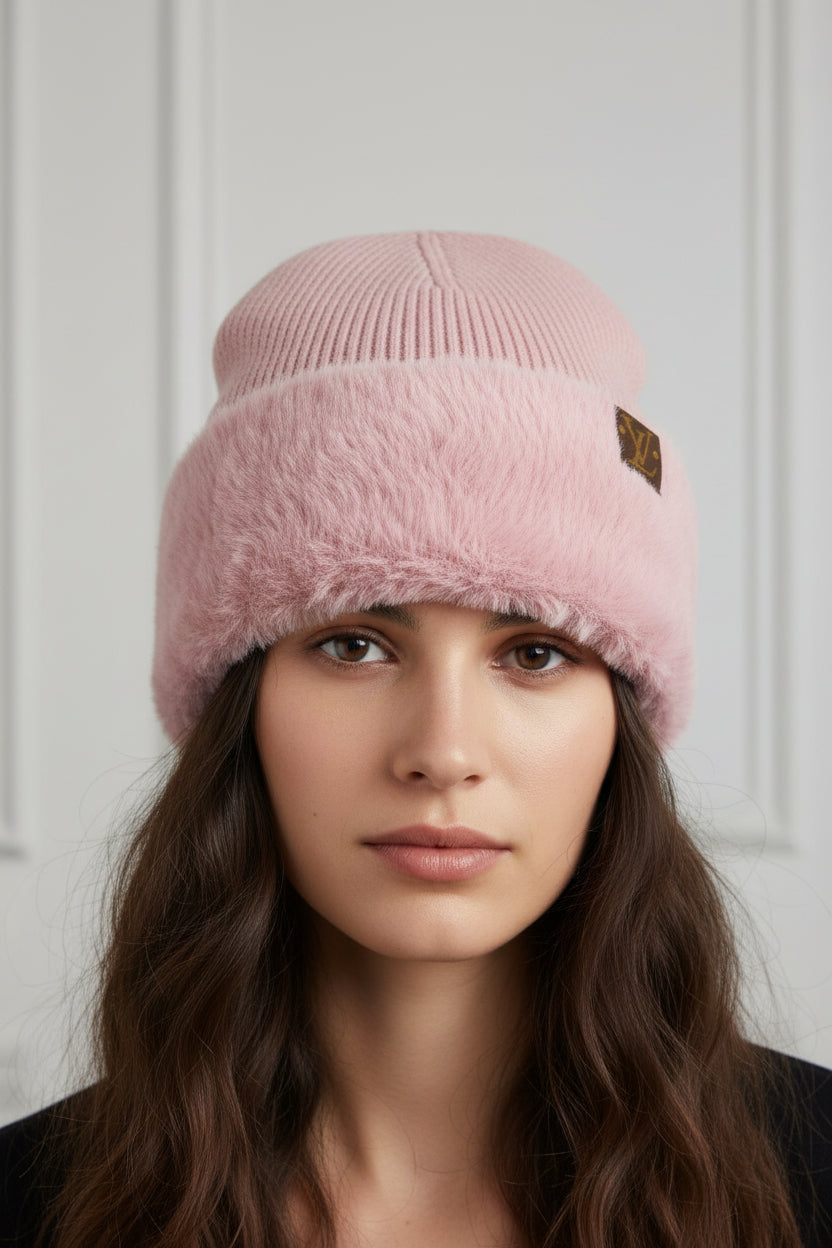 Pink beanie with fuzzy texture and brand logo on a white background