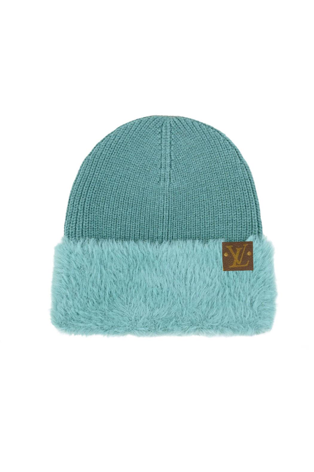 Teal beanie with fur trim and brand logo on a white background