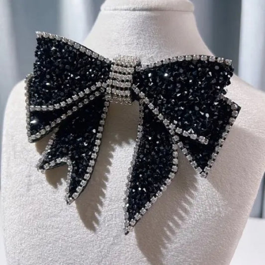 Black and silver bow-shaped decorative piece on a mannequin.