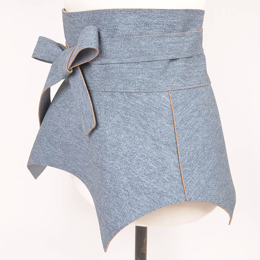 Blue denim apron with a bow on a mannequin against a white background