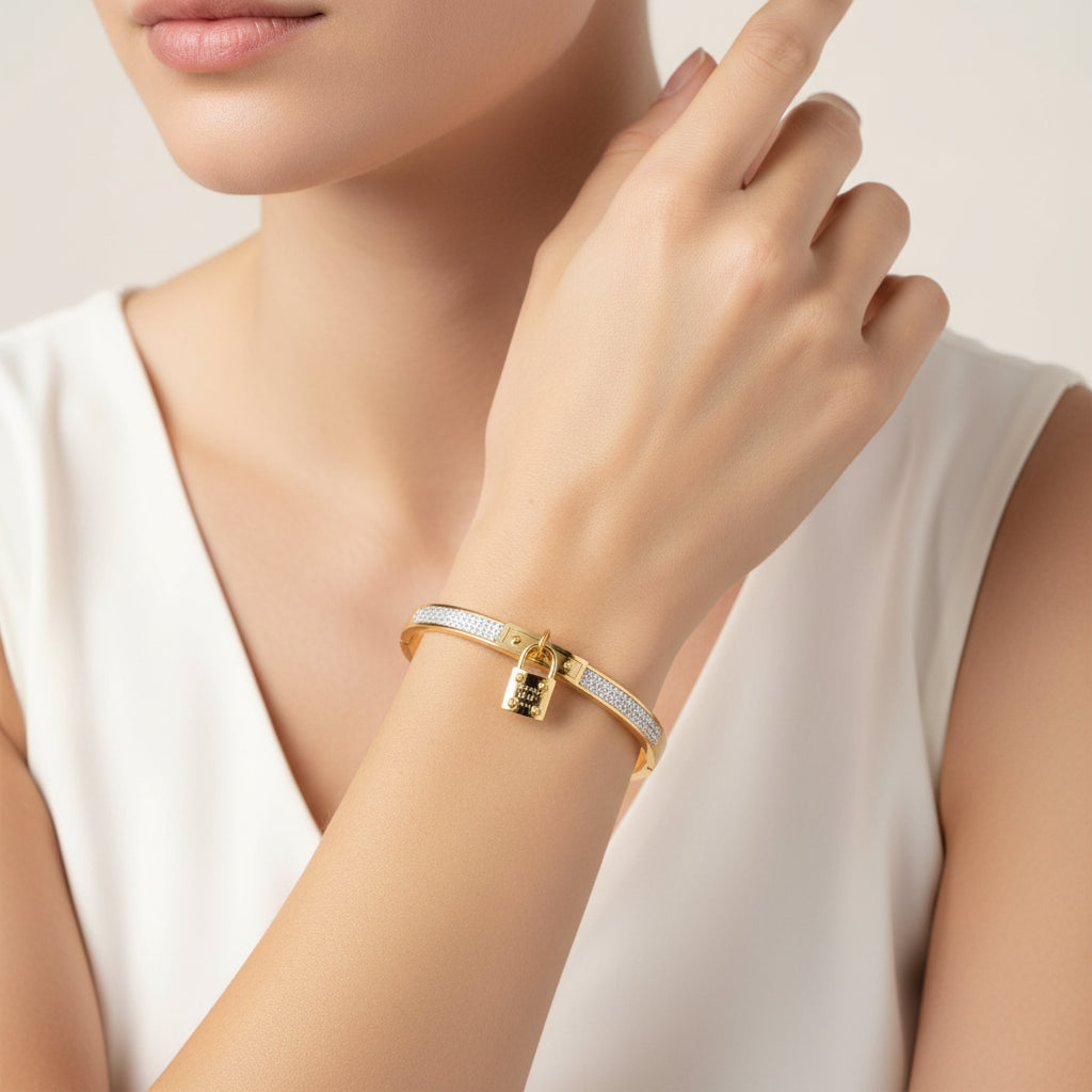 Gold bracelet with diamond accents on a white background