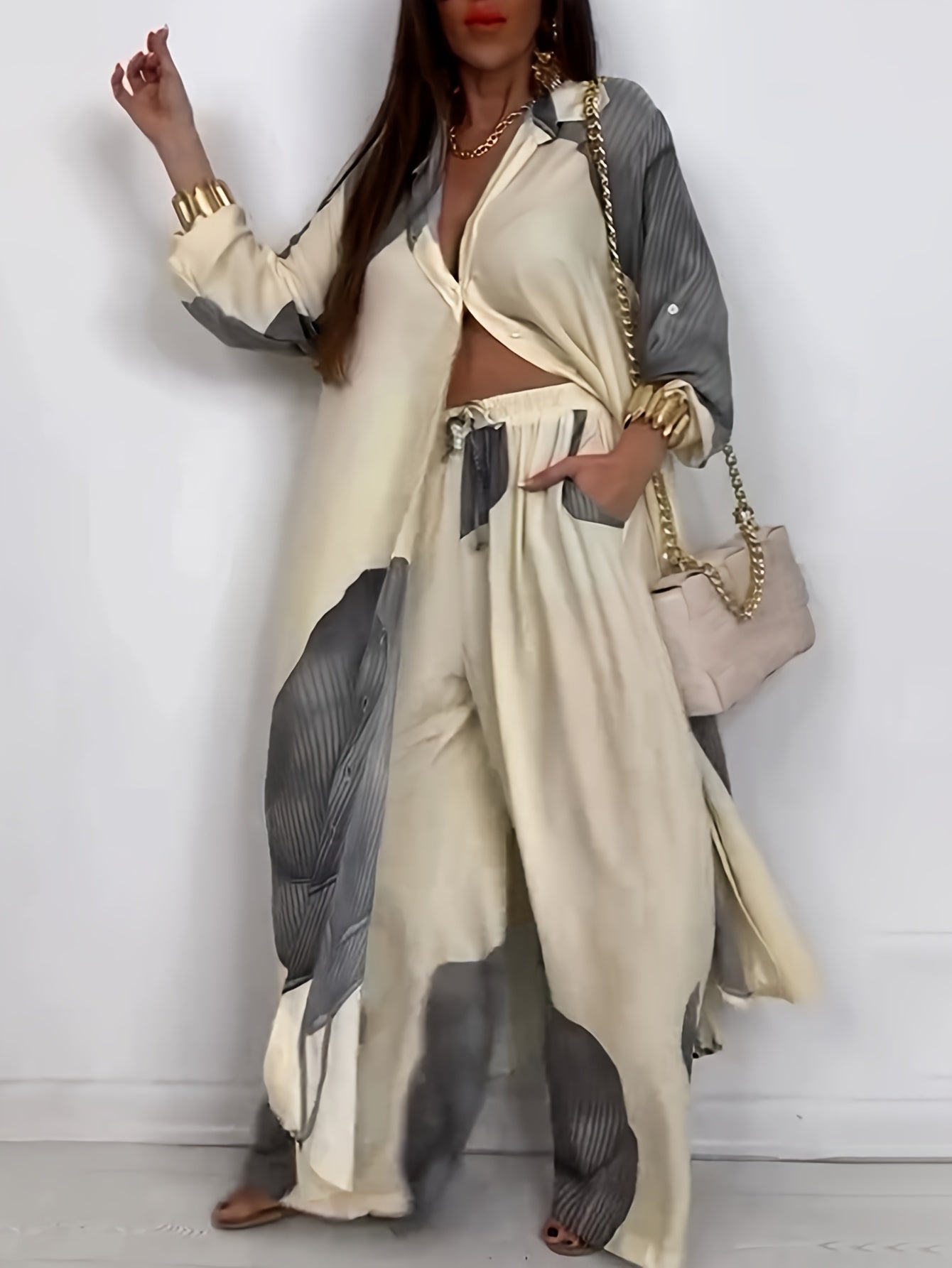 Woman wearing a beige and gray outfit with a matching handbag against a white background