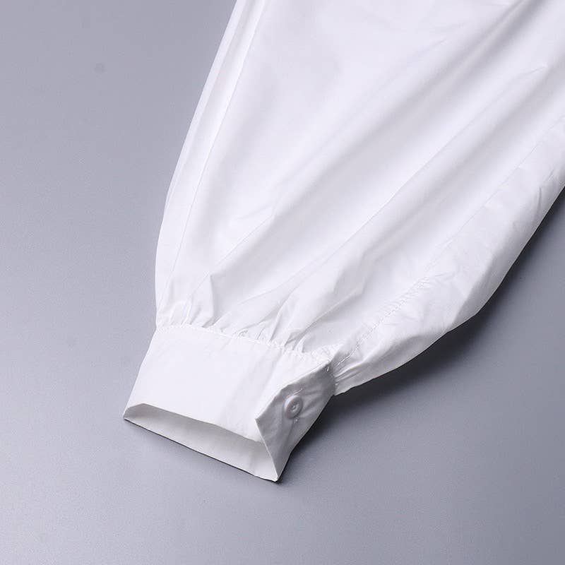 White fabric with a subtle pattern on a gray background