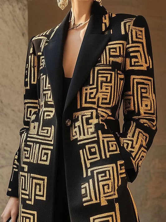 Black blazer with gold geometric pattern worn by a model against a neutral background