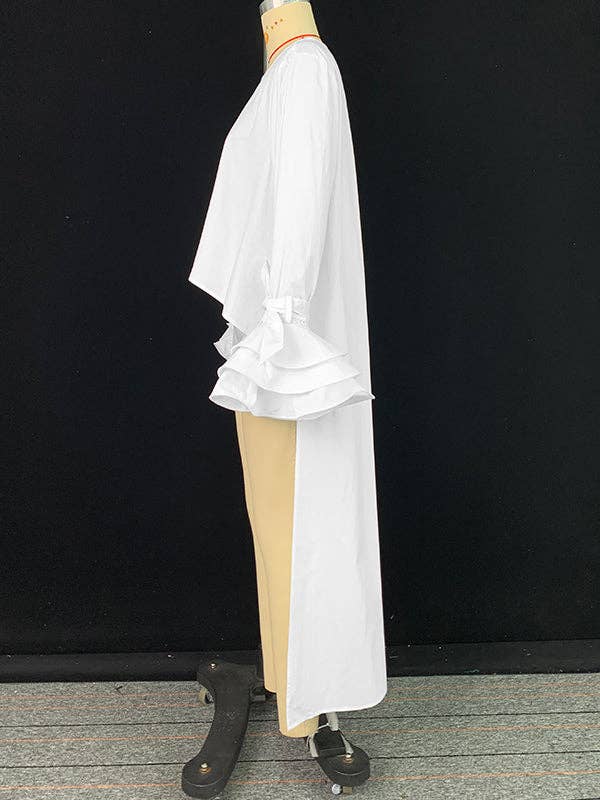 Mannequin wearing a white kimono-style garment with beige underlayer against a black background