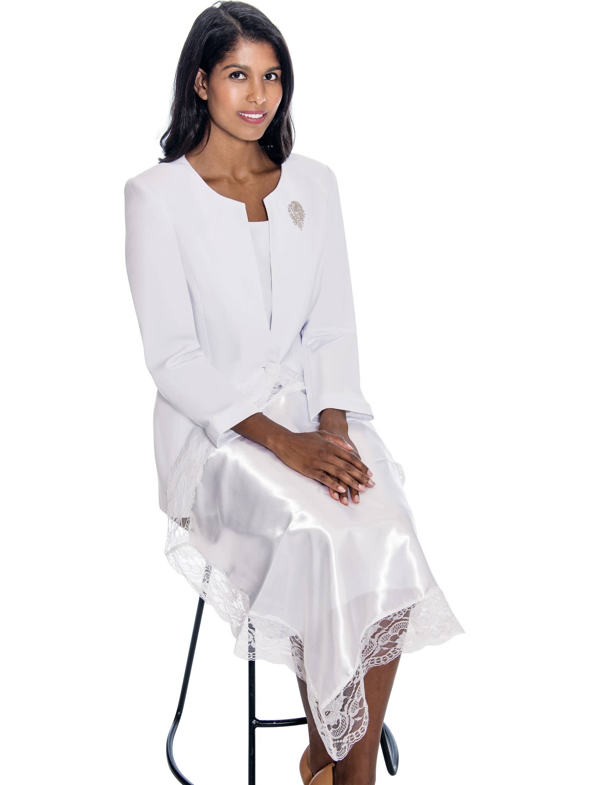 Woman wearing a white satin dress with lace details on a white background