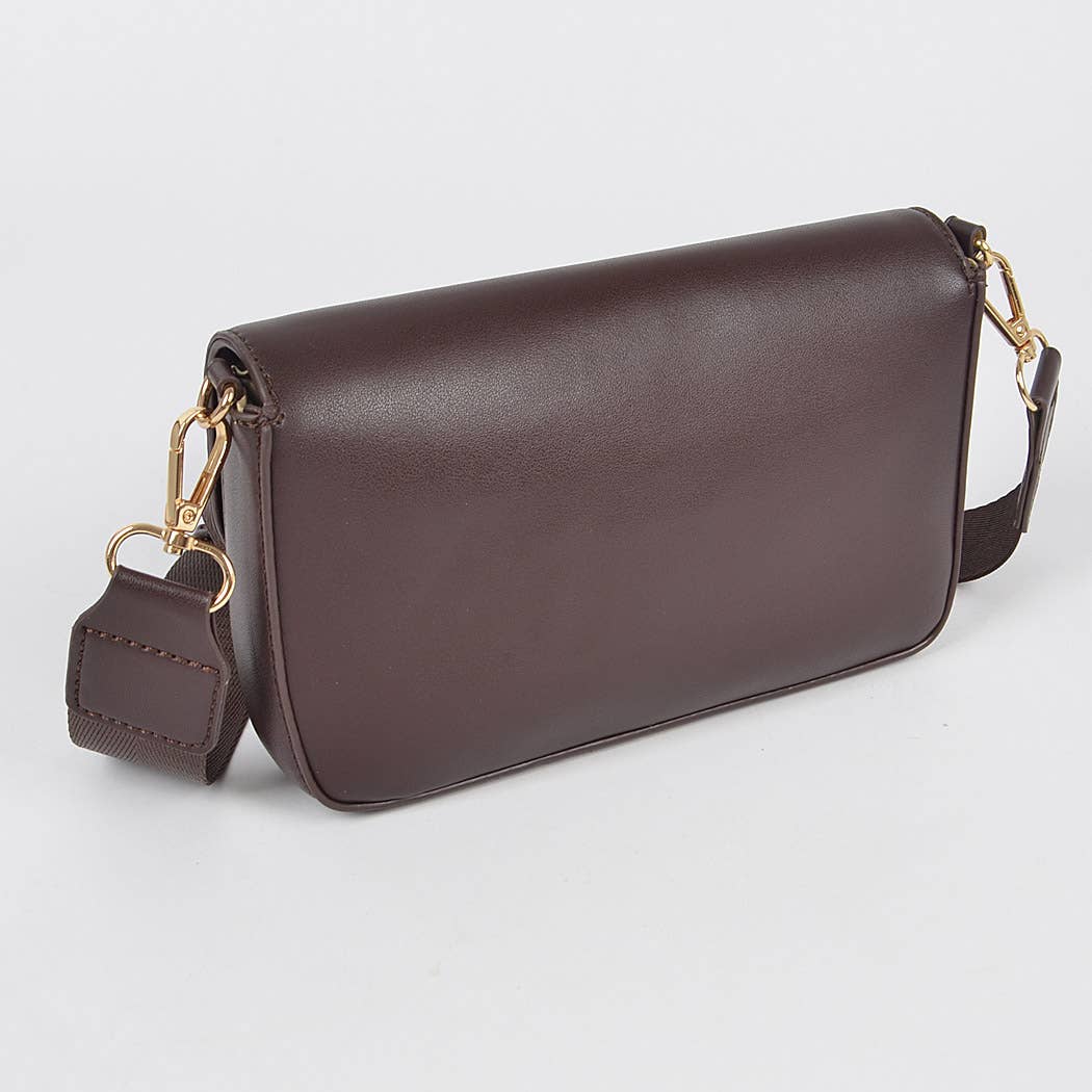 Brown leather handbag with gold accents on a light gray background