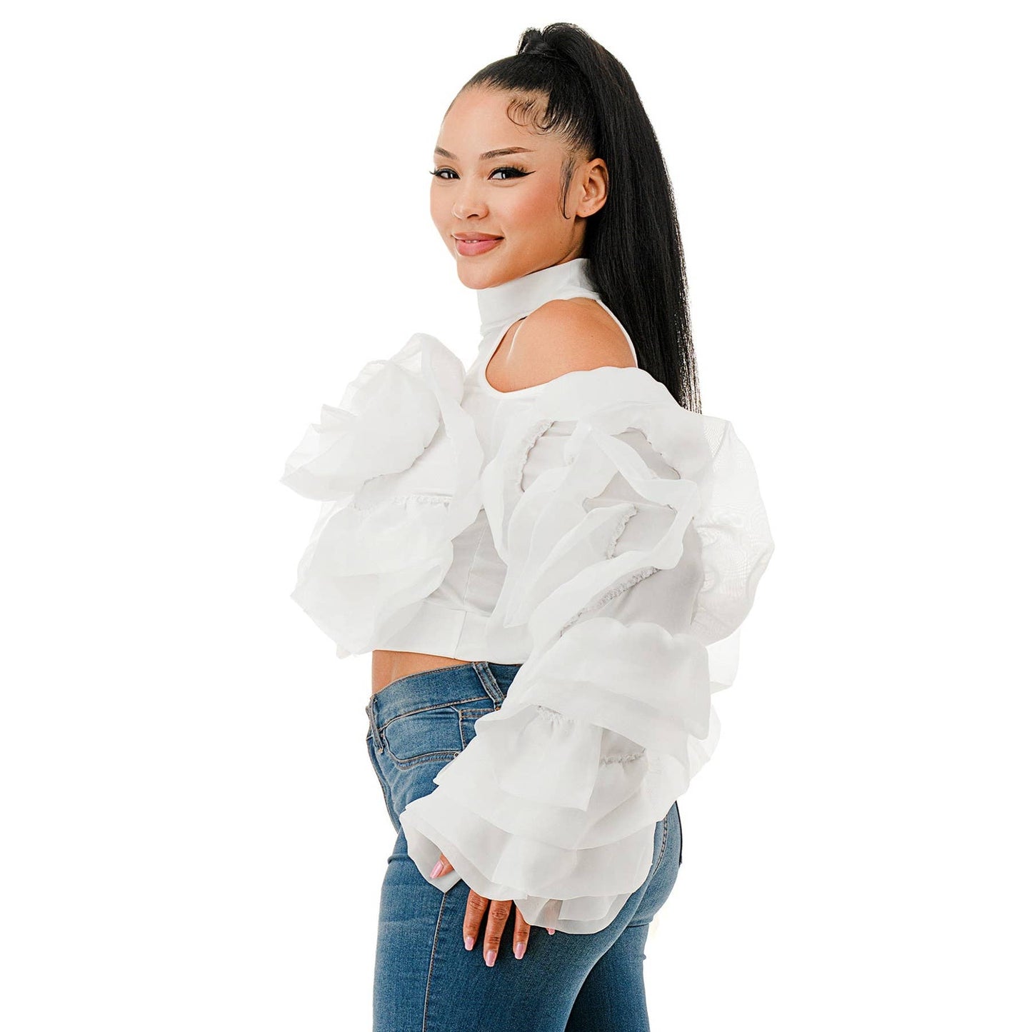 Woman wearing a white off-shoulder top and blue jeans on a white background