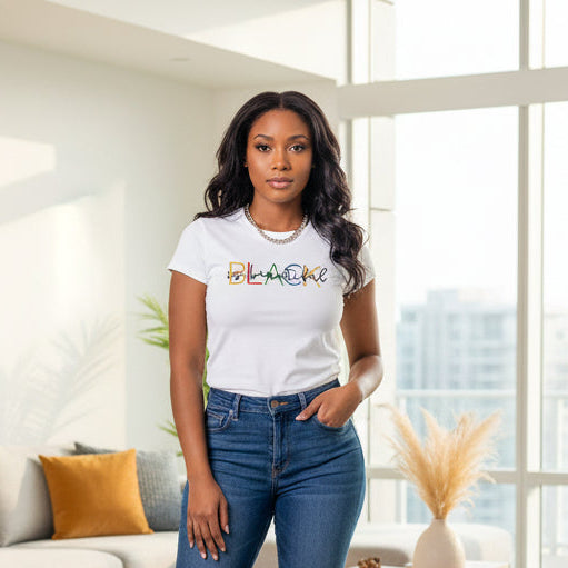 White t-shirt with 'Black is Beautiful' text in colorful letters worn by a person.