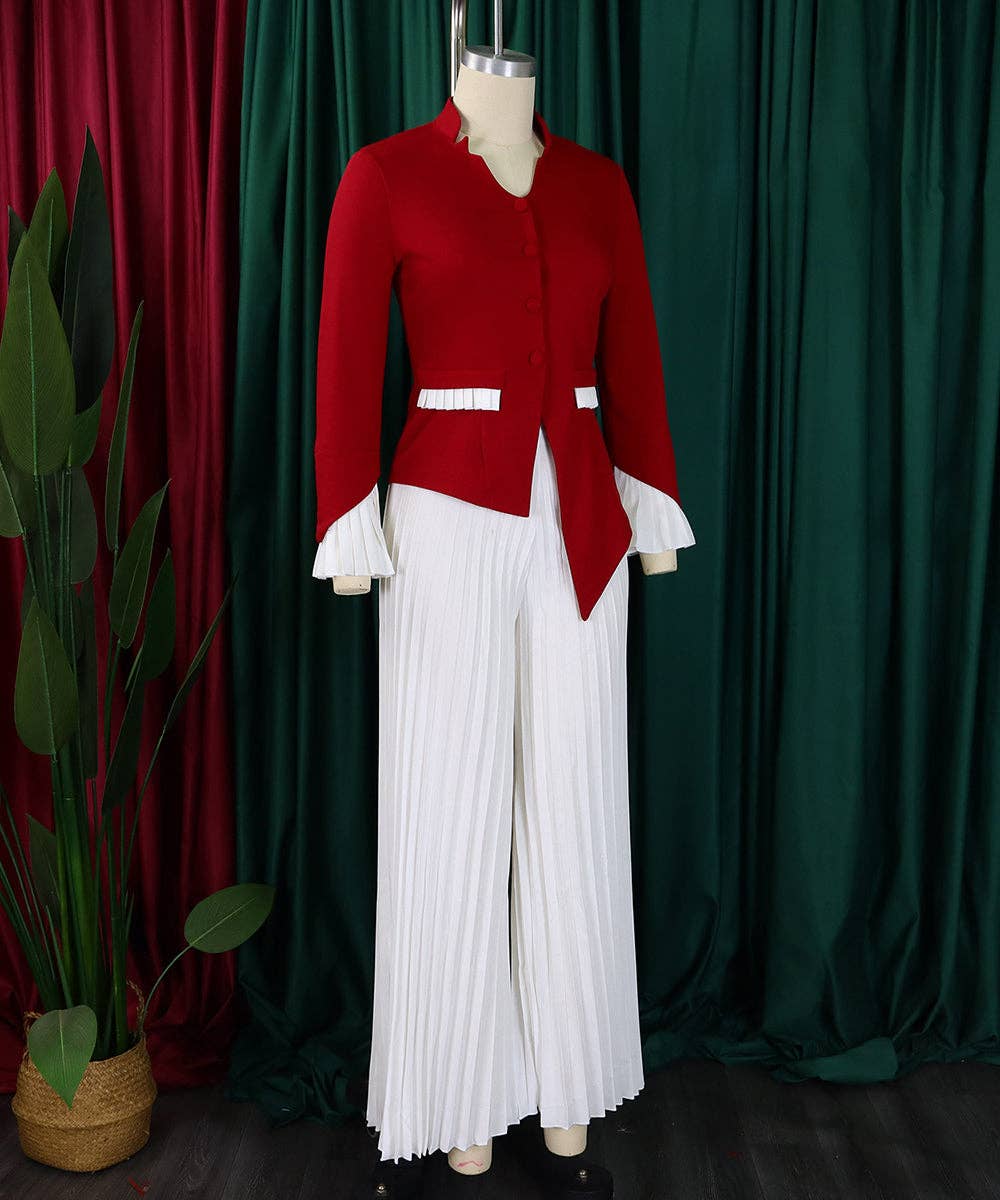 Red jacket and white pleated pants on a mannequin against a green curtain background