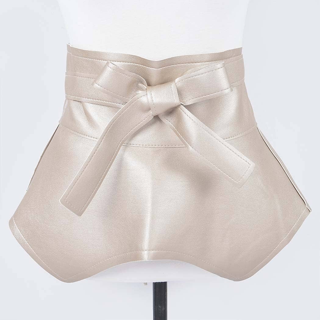 Beige leather skirt with a large bow on a white background