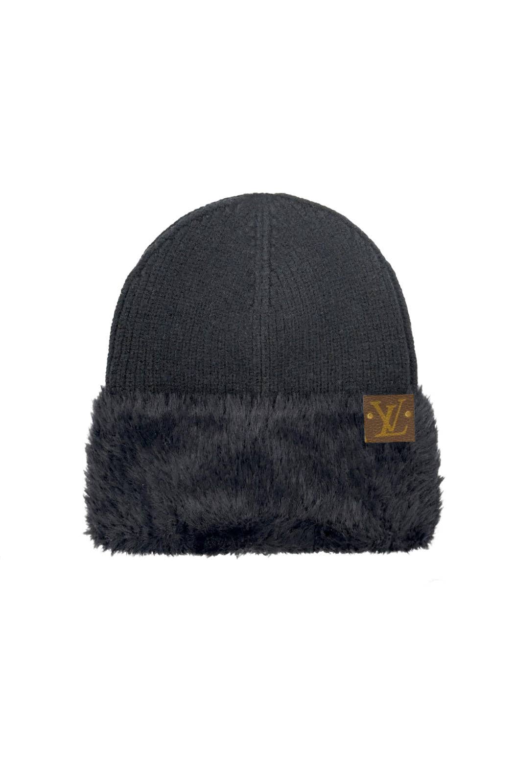 Dark gray beanie with fur trim and a logo patch on a white background