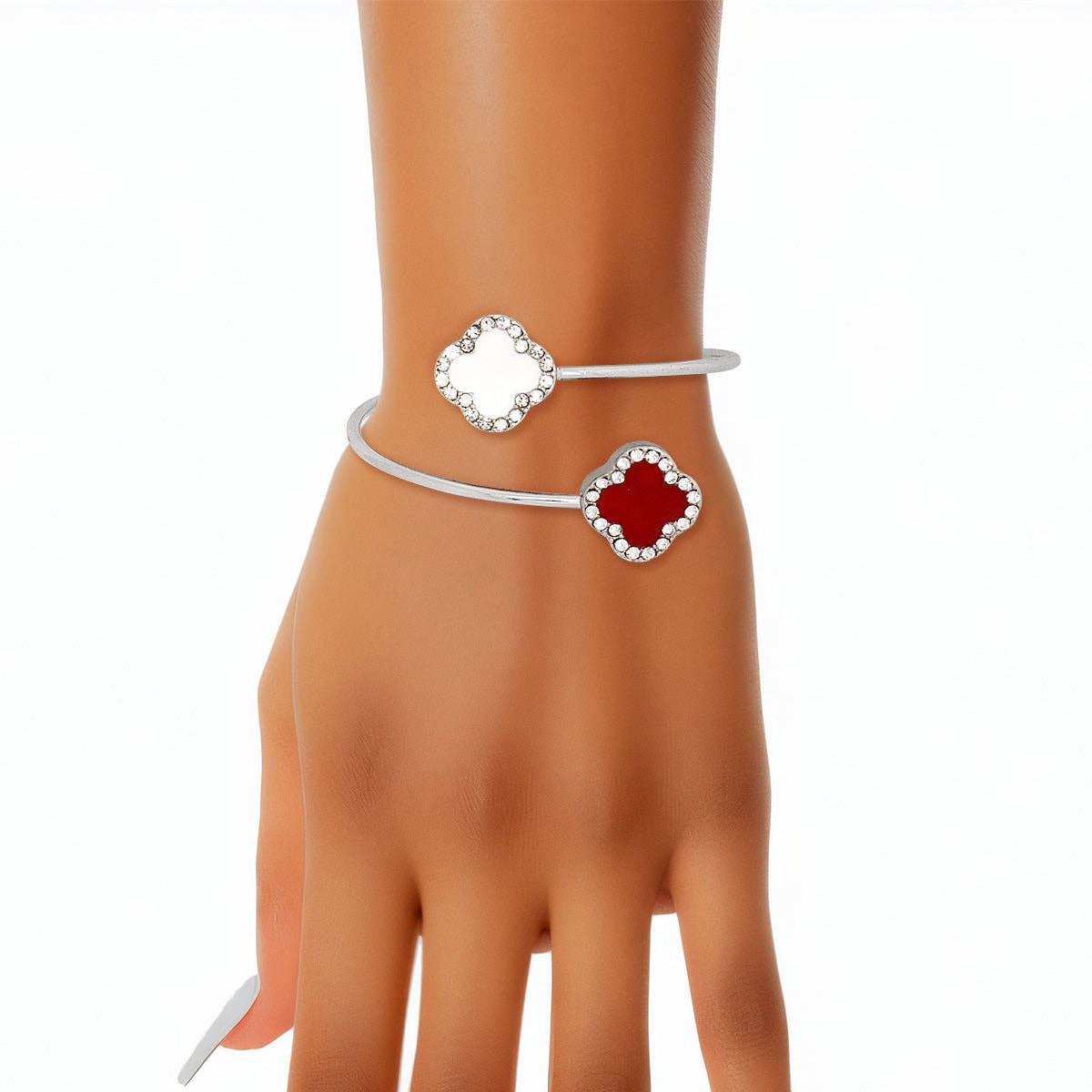 Silver bracelet with red gemstone on a mannequin hand against a white background