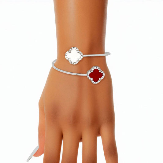 Silver bracelet with red gemstone on a mannequin hand against a white background