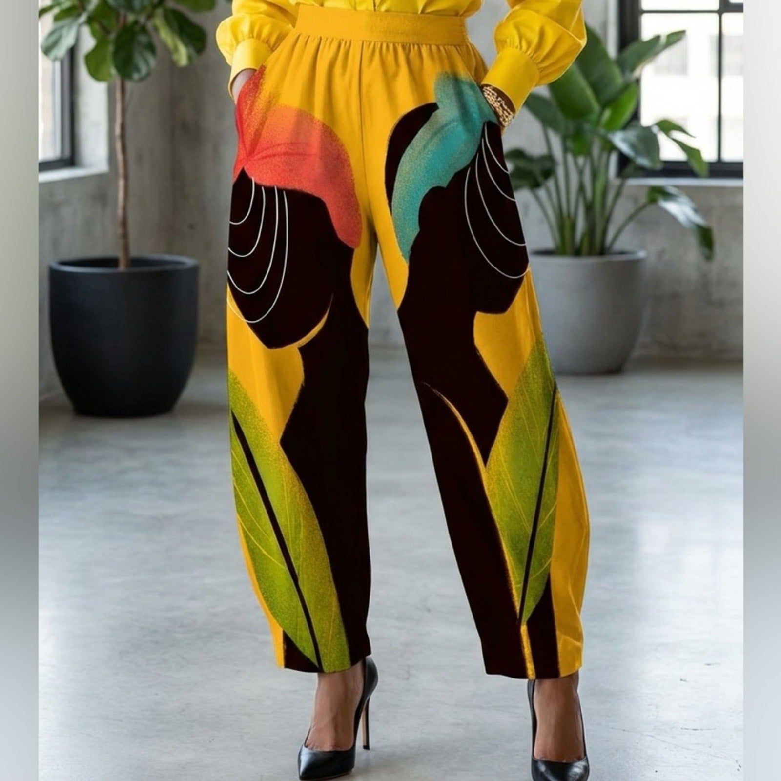 Person wearing a bright yellow outfit with colorful patterned pants in an indoor setting.