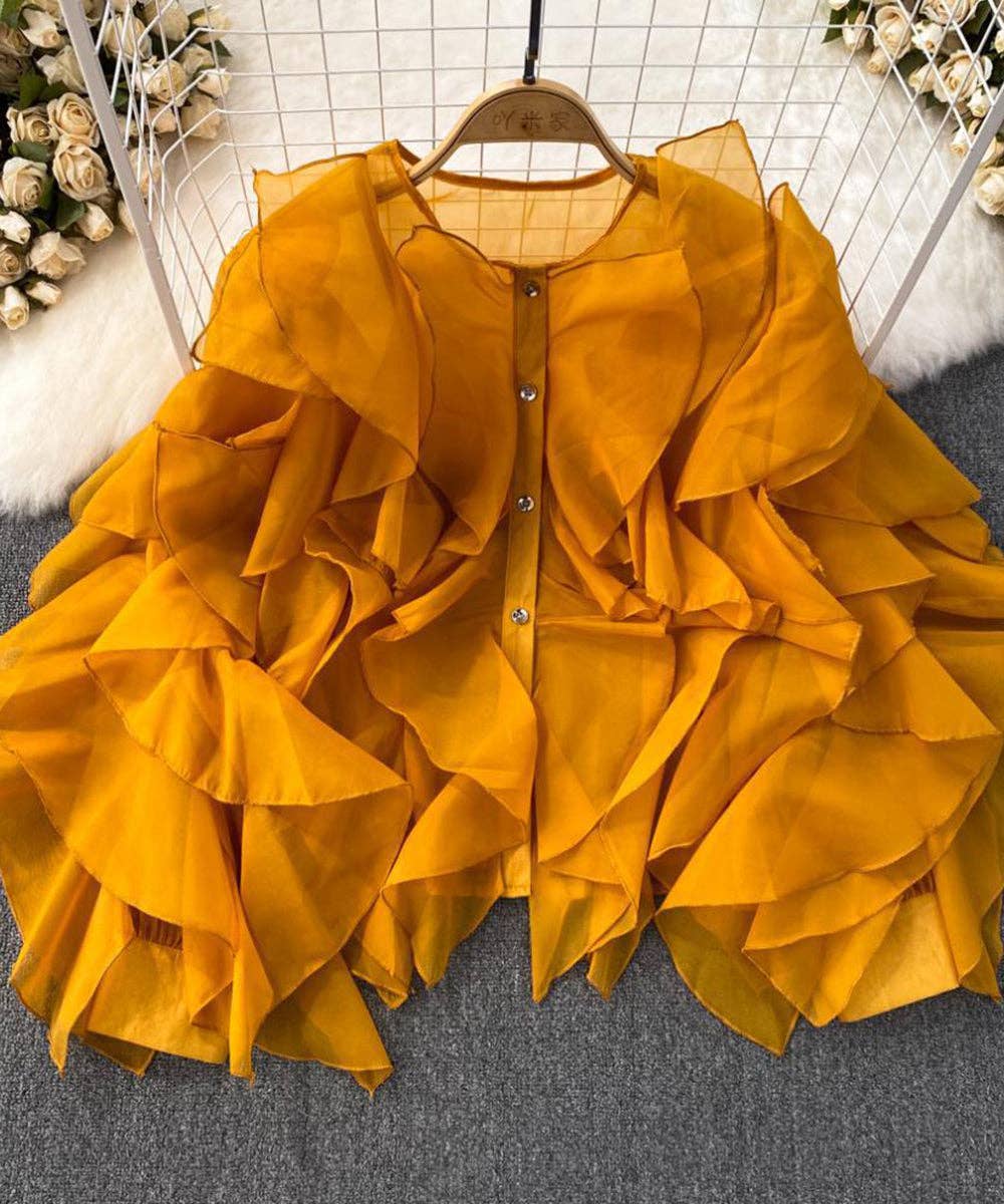 Yellow ruffled jacket on a hanger with a neutral background
