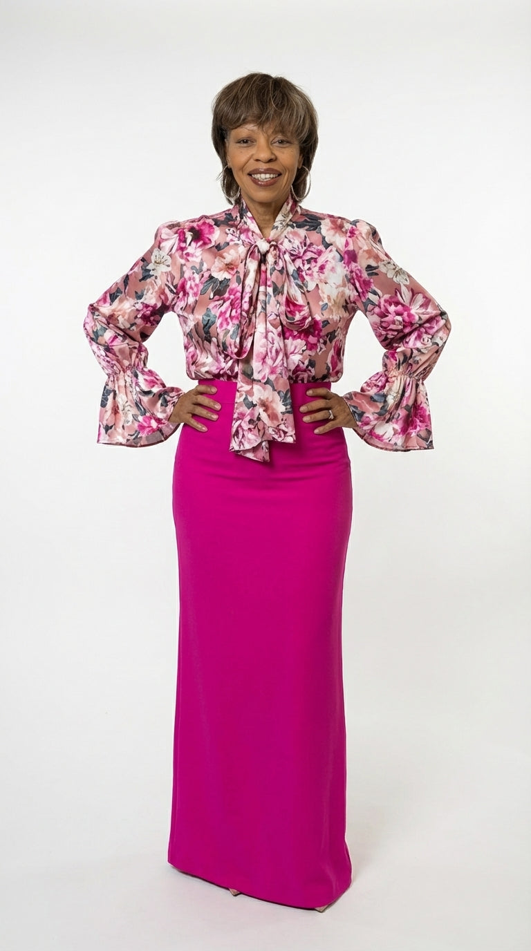 Woman wearing a floral blouse and pink skirt on a white background
