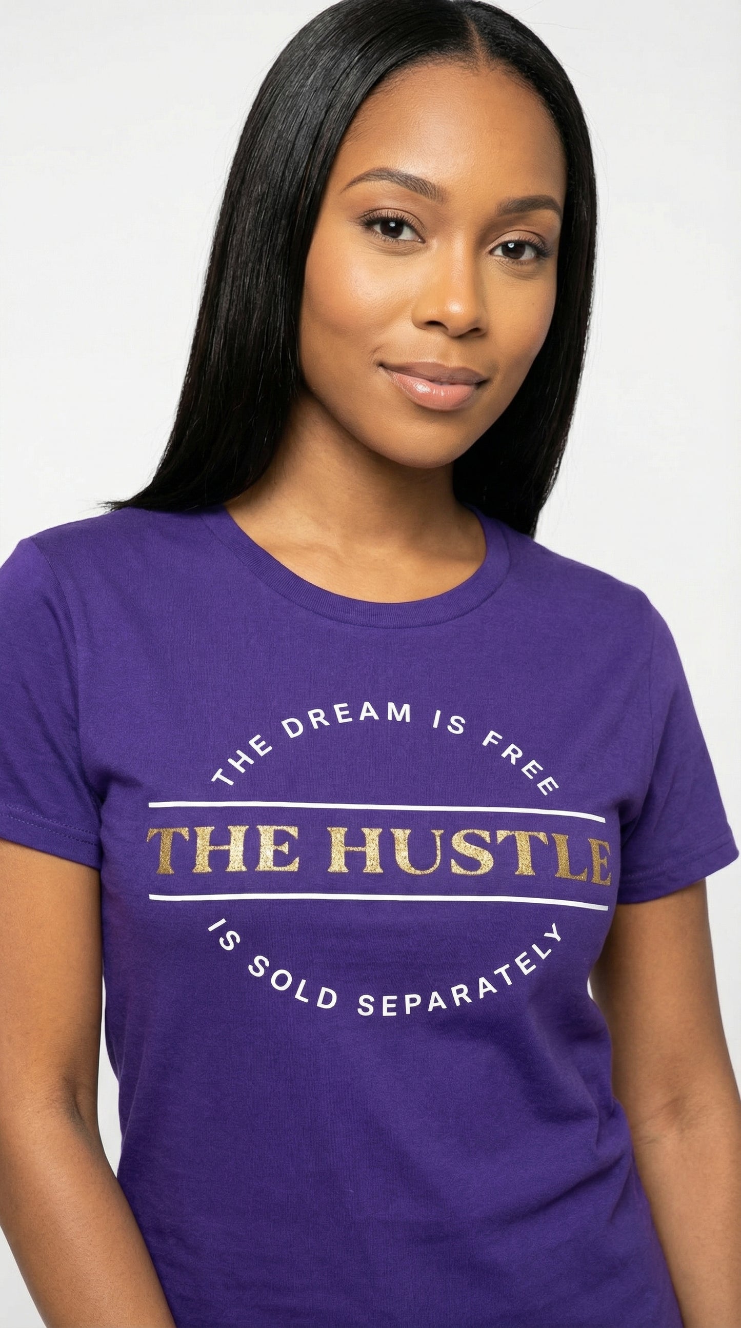 Woman wearing a purple t-shirt with motivational quote on a plain background