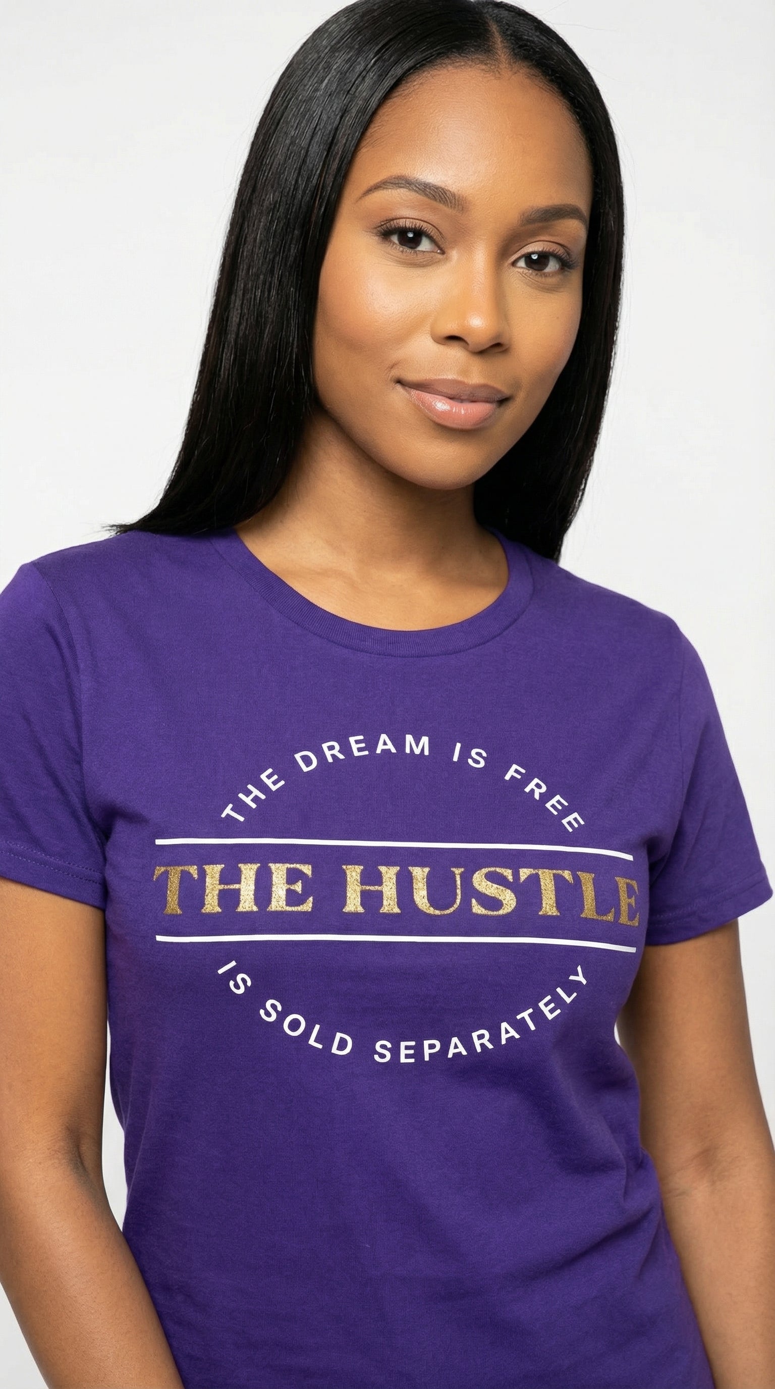 Woman wearing a purple t-shirt with motivational quote on a plain background