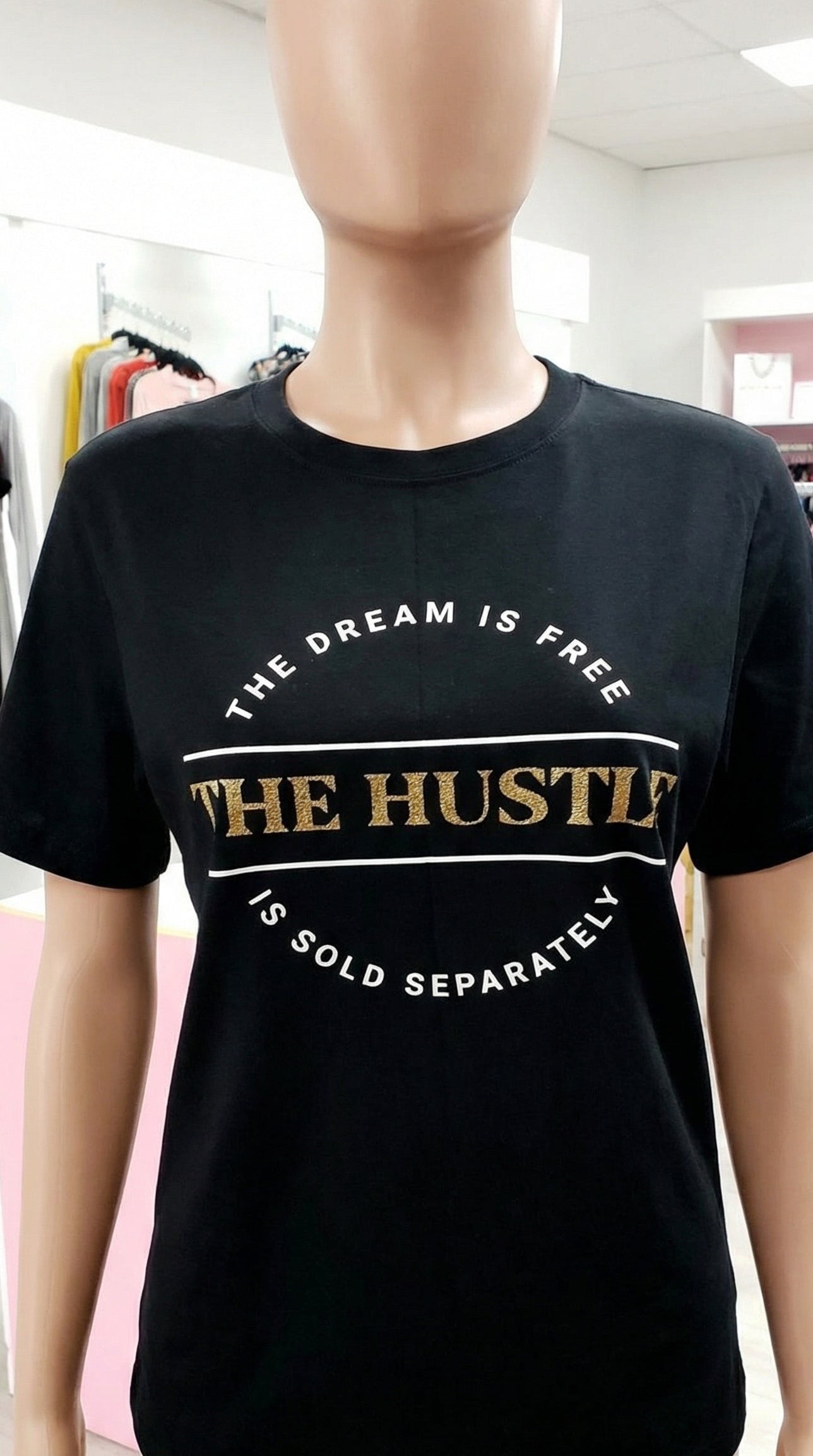 Black t-shirt with text on a mannequin in a store setting