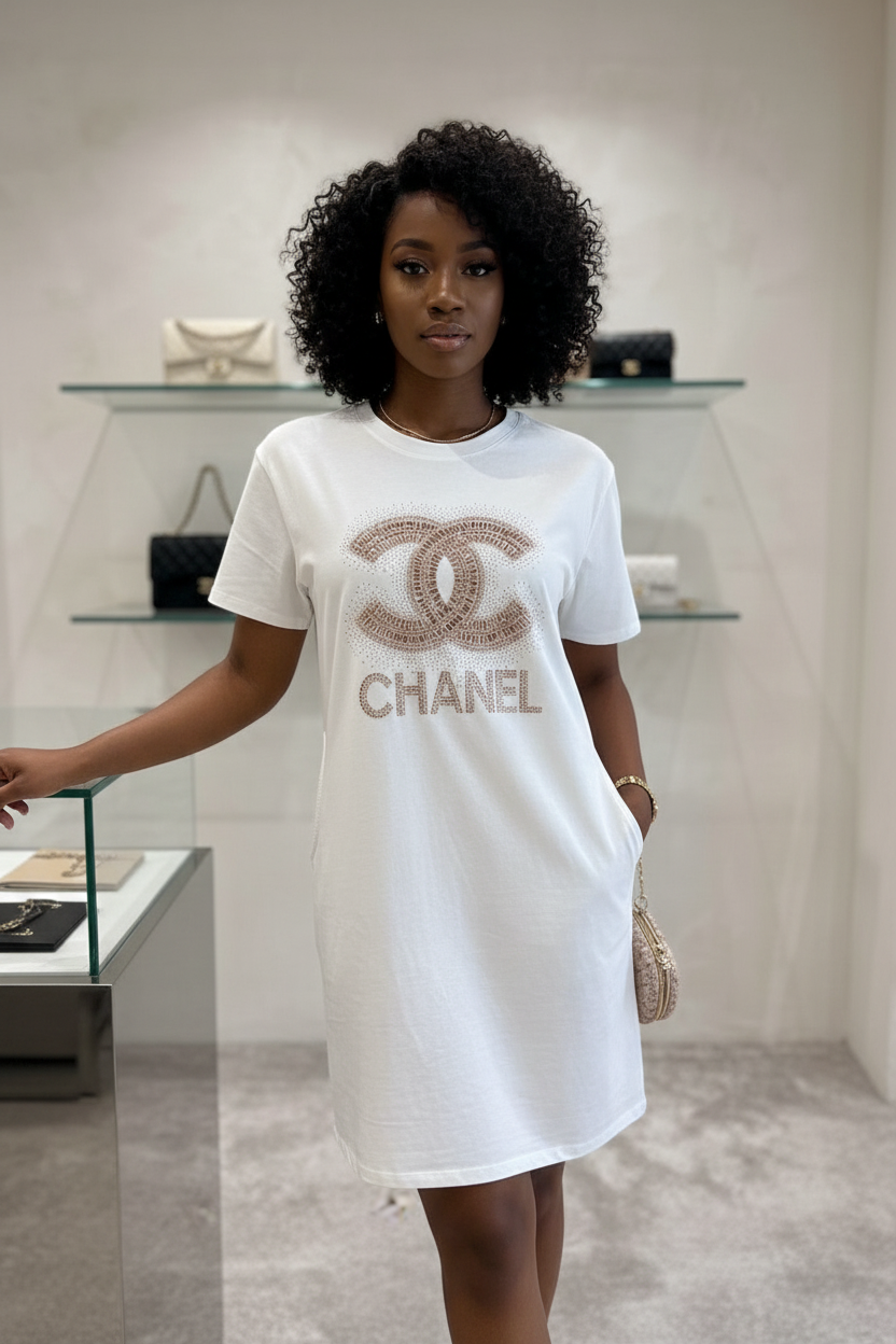 Person wearing a white t-shirt with Chanel logo in a store setting